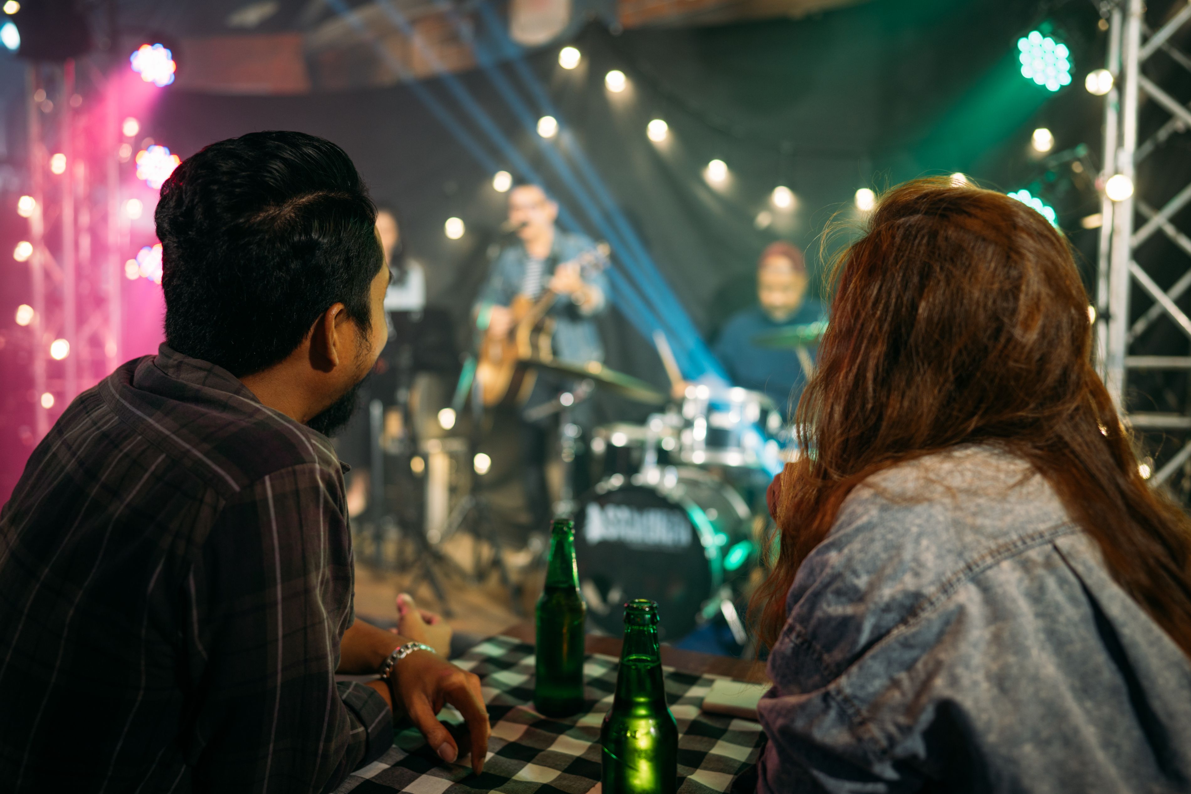 couple sitting at a table watching a concert