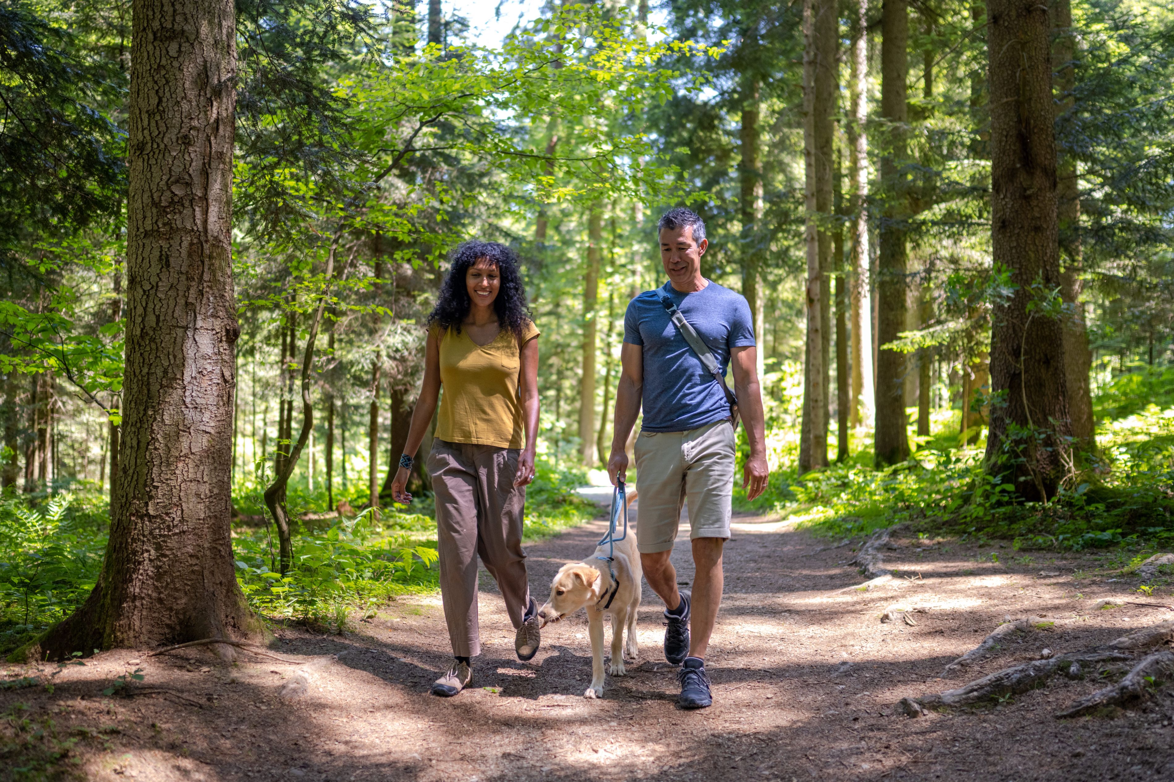 couple hiking with a dog