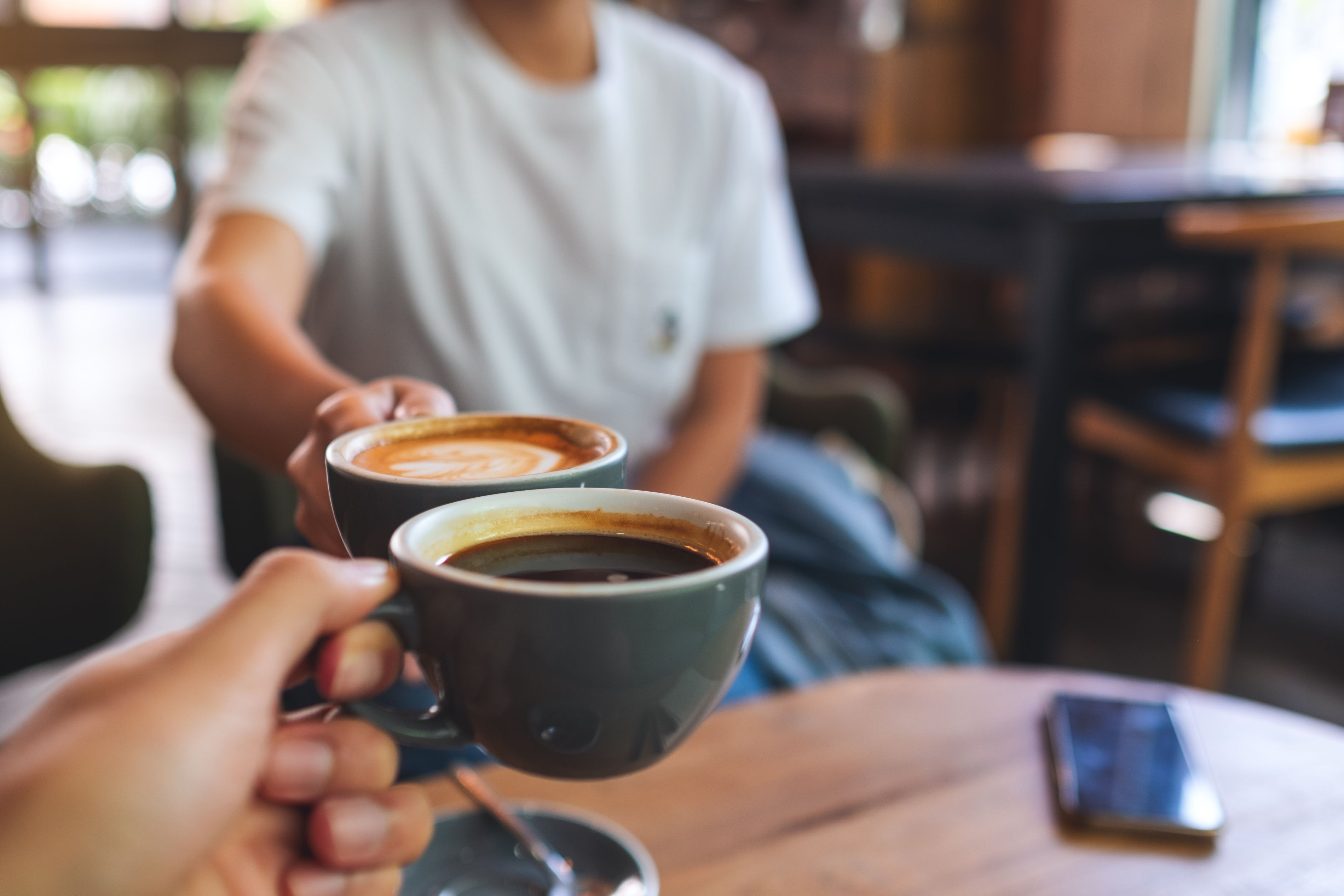people cheersing with coffee cups