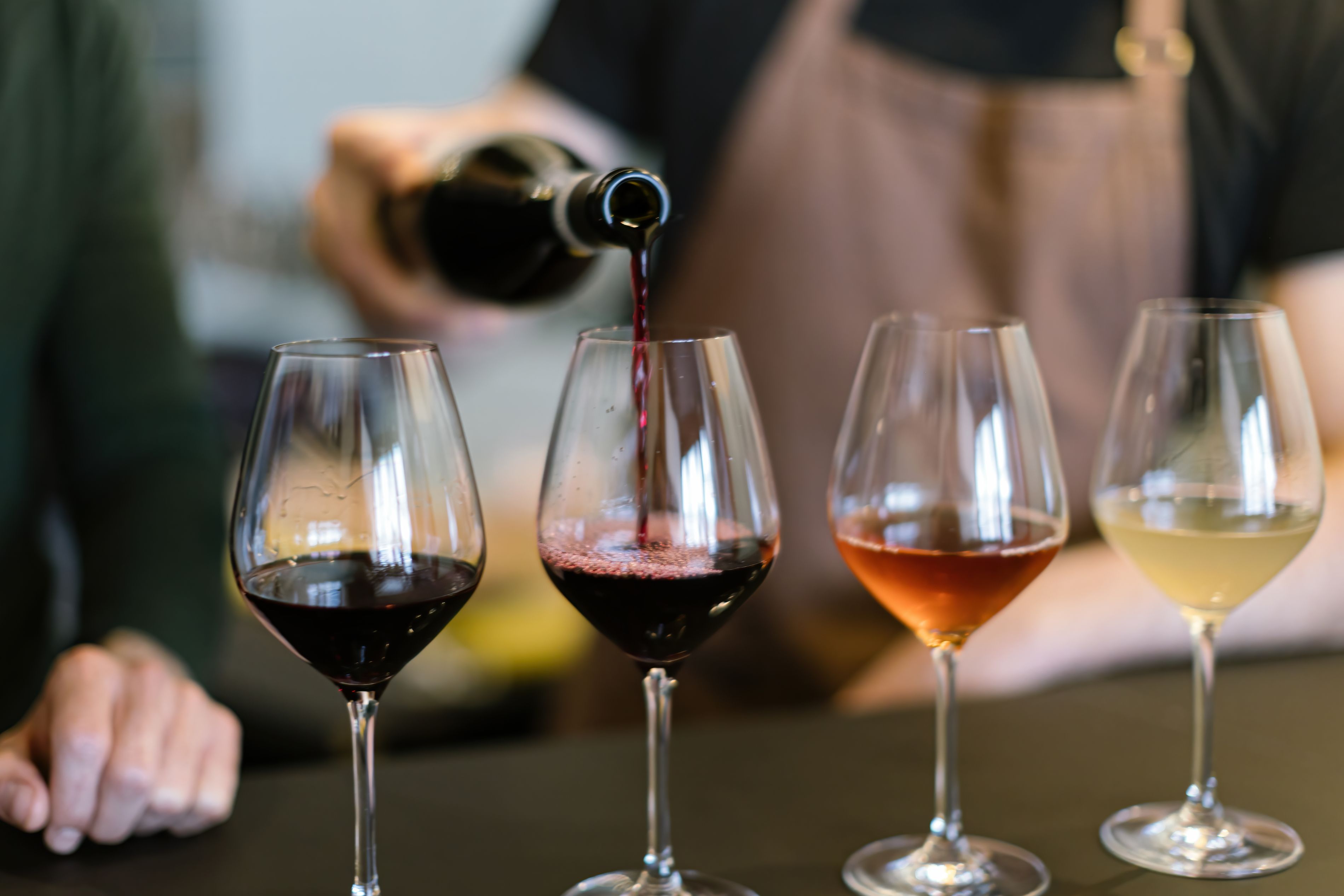 employee pouring a wine flight