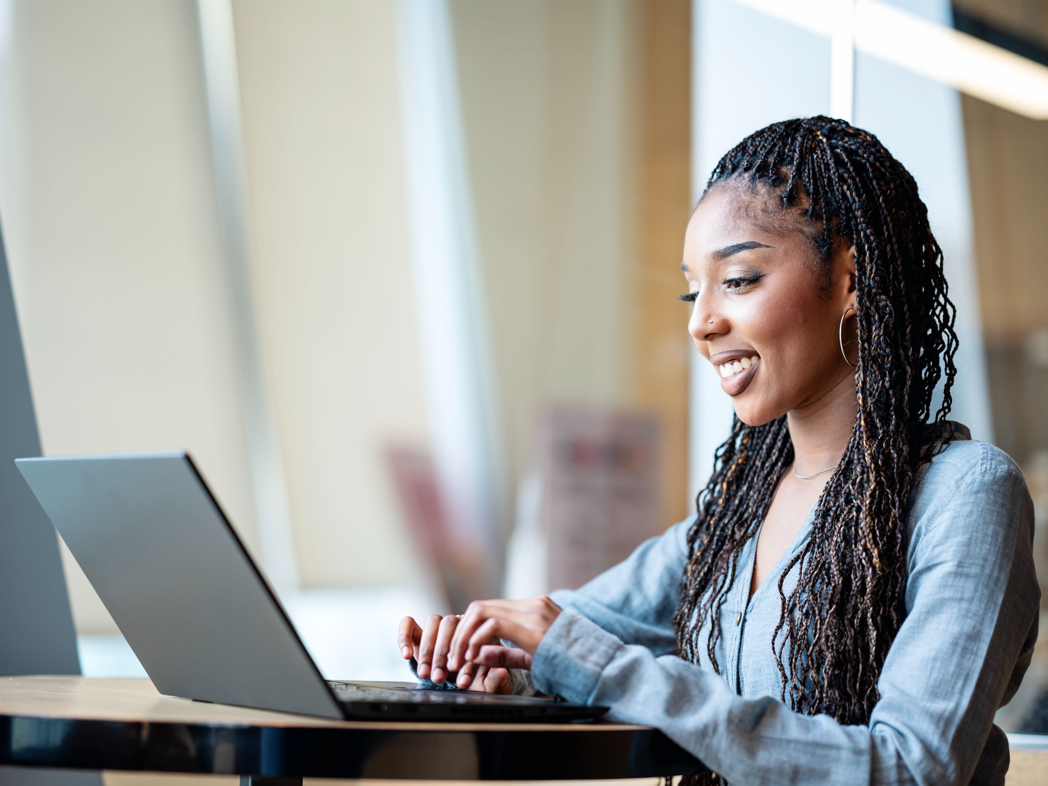 Woman working on a laptop.