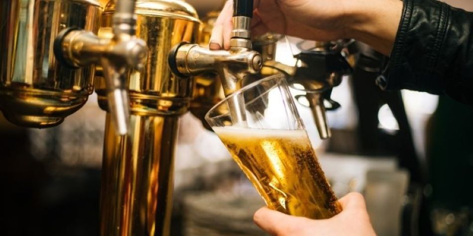 Bartender getting beer from the tap.