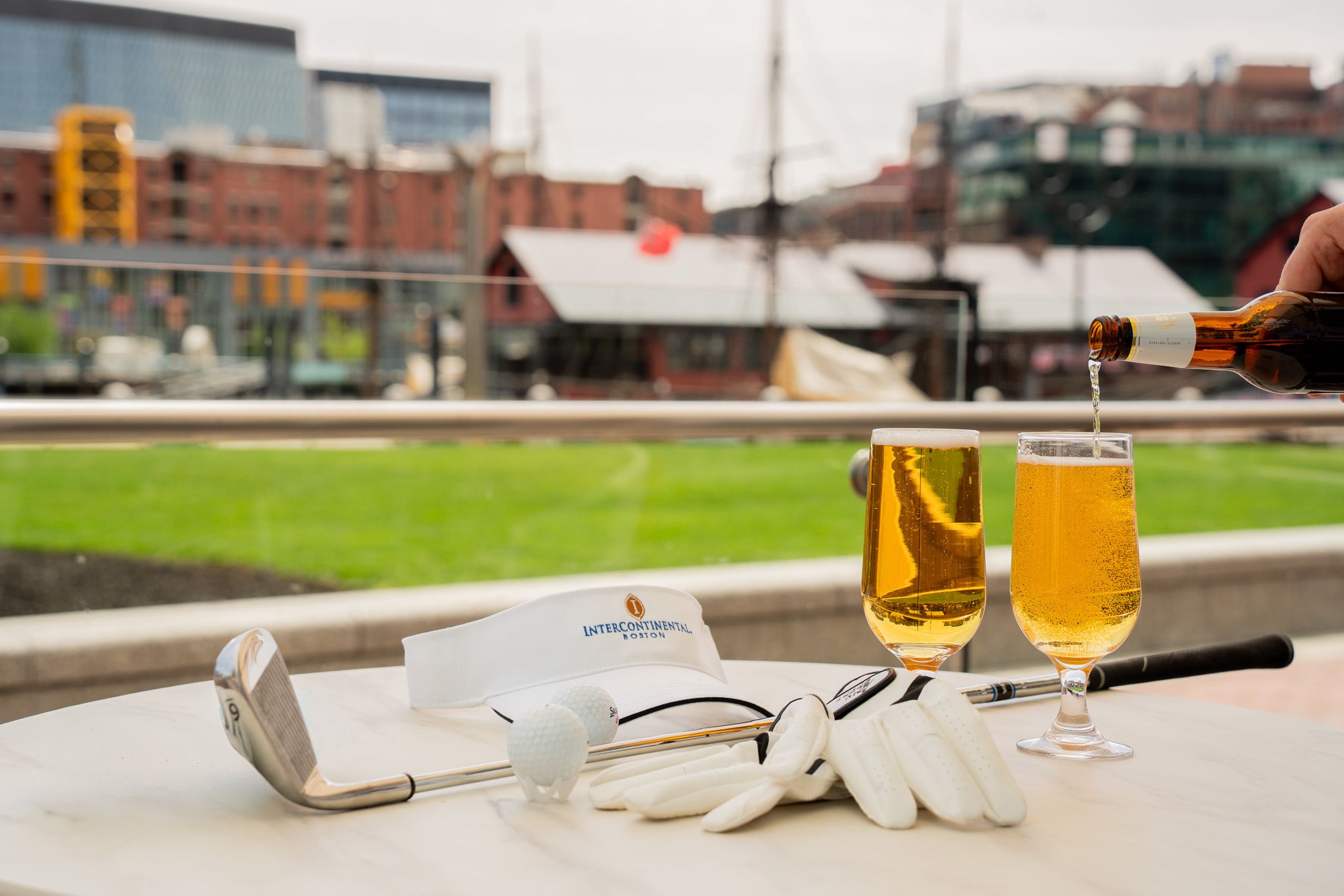 Table with two beers and golf equipment.