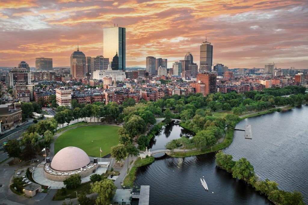 Boston skyline with Hatch Memorial Shell and the Charles River in the foreground.