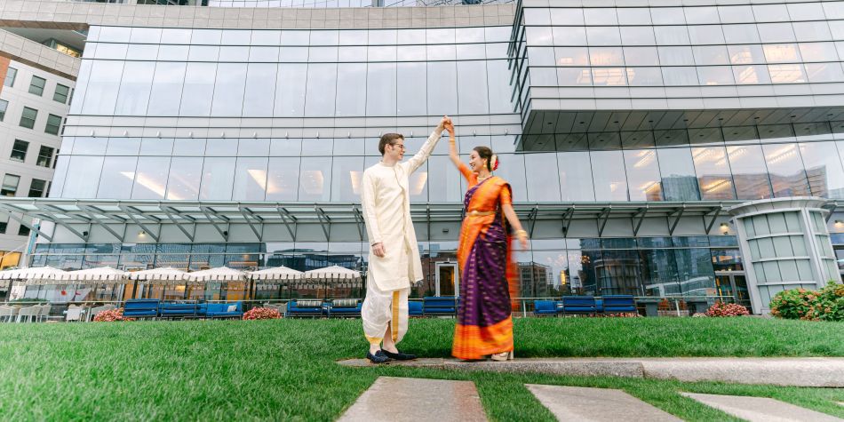 Bride and groom outside in traditional Indian wedding garments.