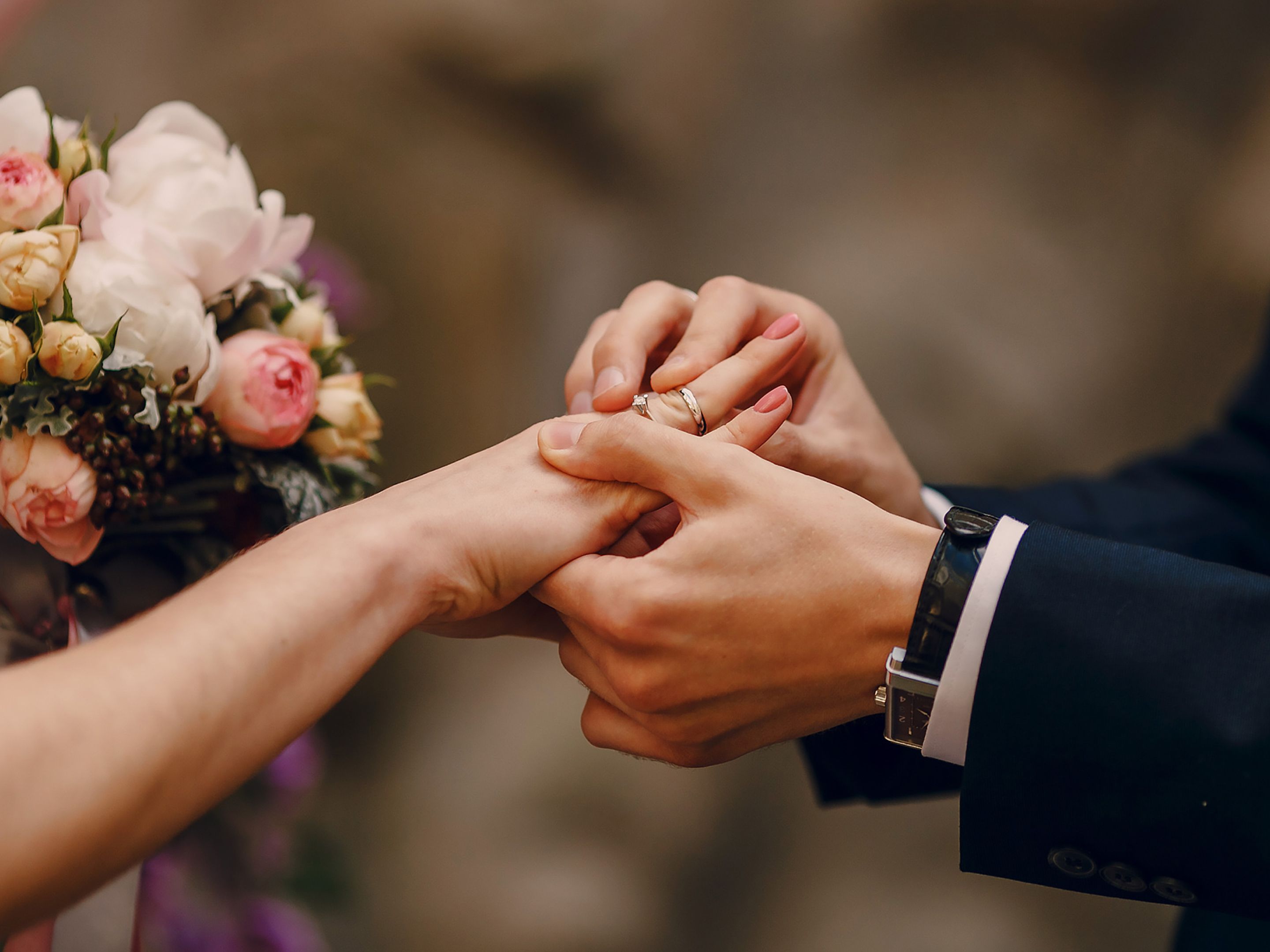 Bride and groom exchanging rings.