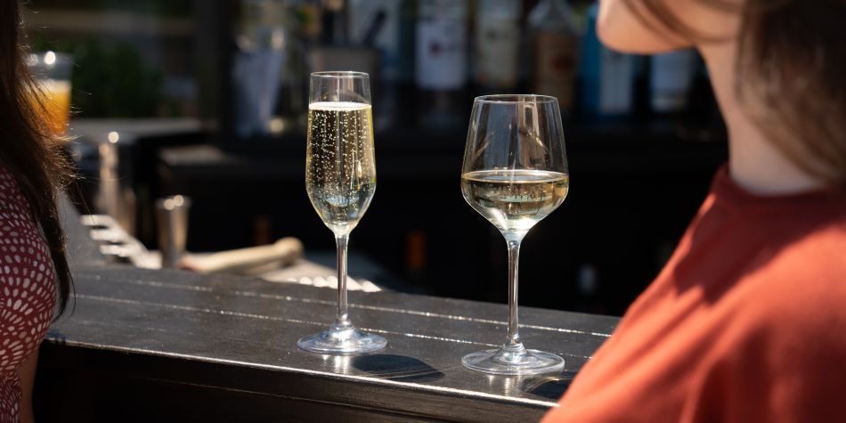 A glass of white wine and champagne.