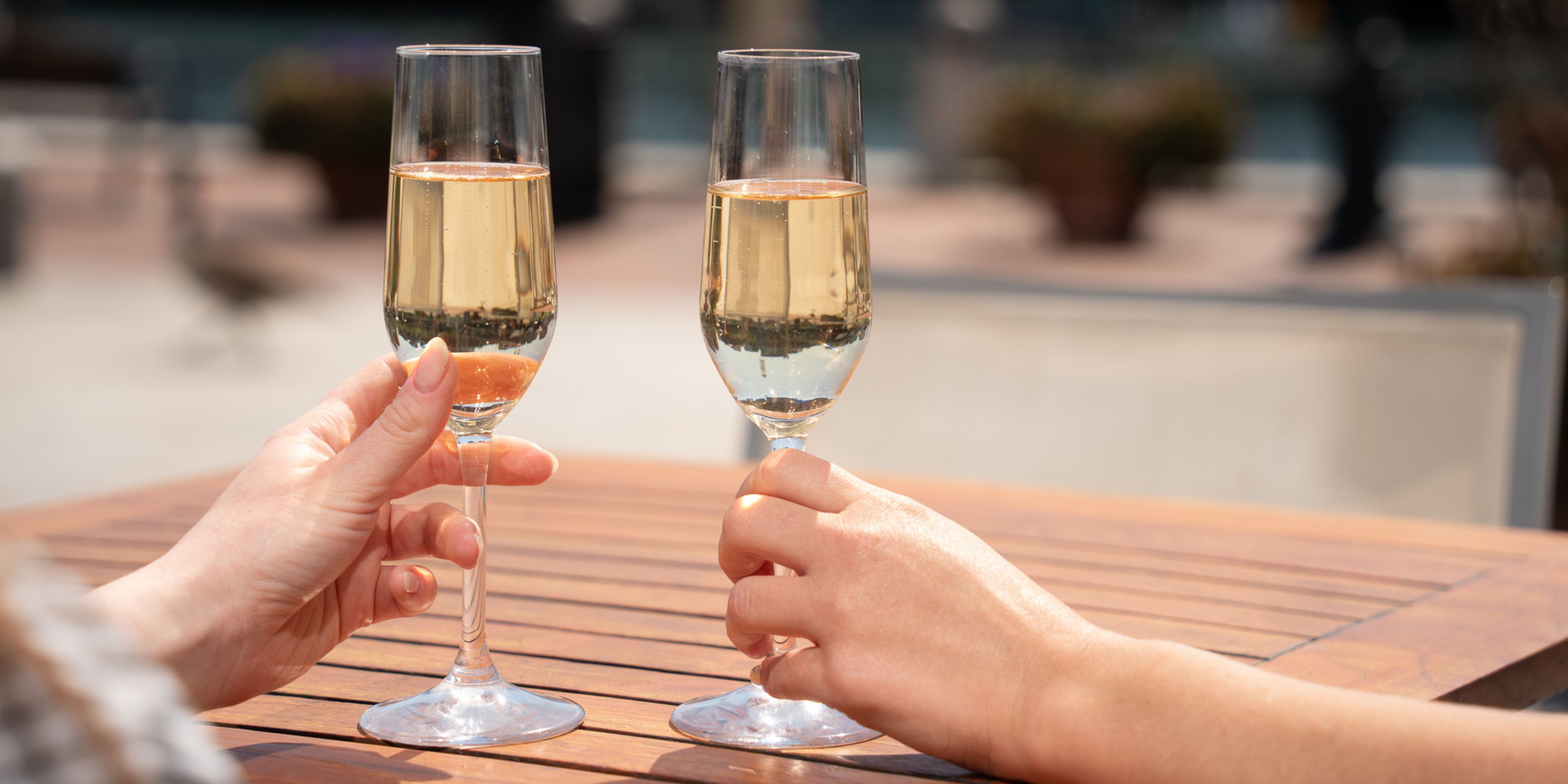 Champagne glasses held by guests at 510 Waterfront Bar.