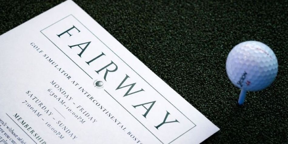 Fairway information flyer next to a golf ball on a tee.