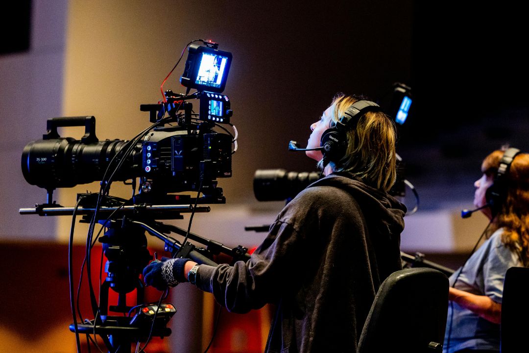 Camera crew directing and filming a scene.