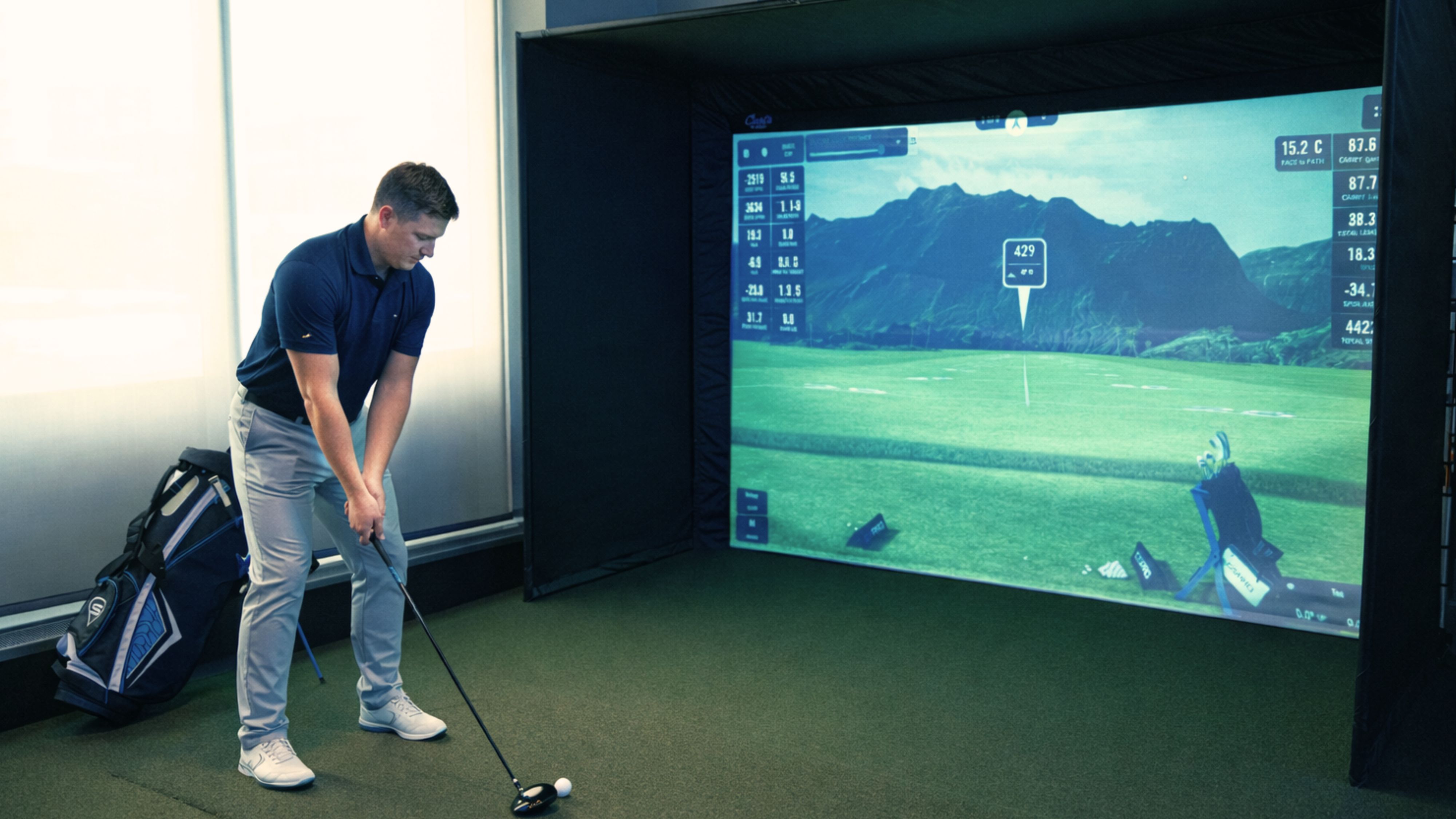 man playing golf on golf simulator