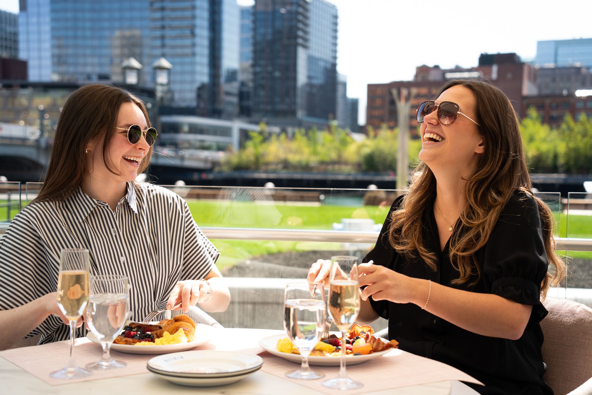 Two women enjoying dinner on the waterfront.
