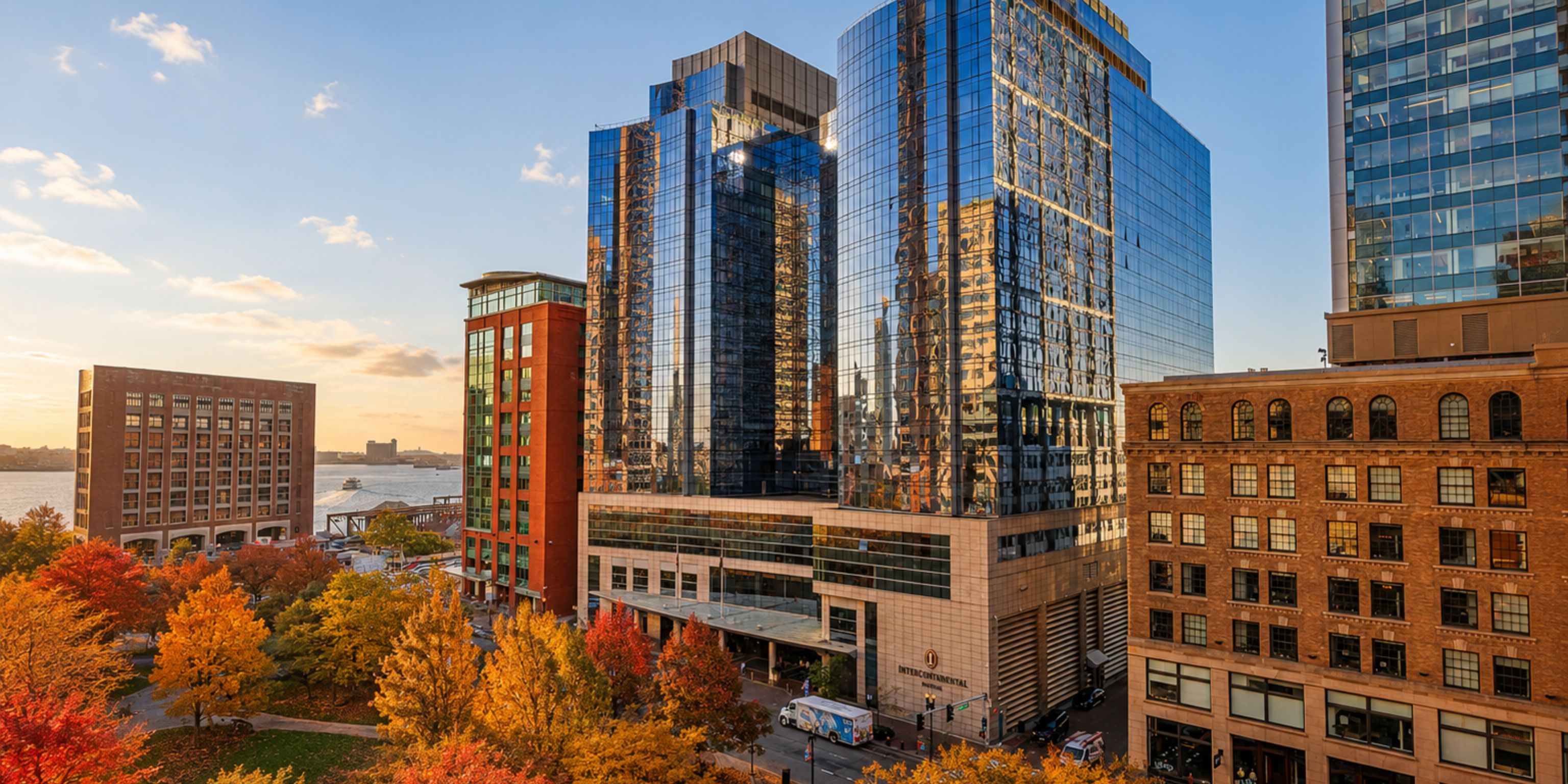InterContinental Boston hotel by the harbor amid fall foliage.