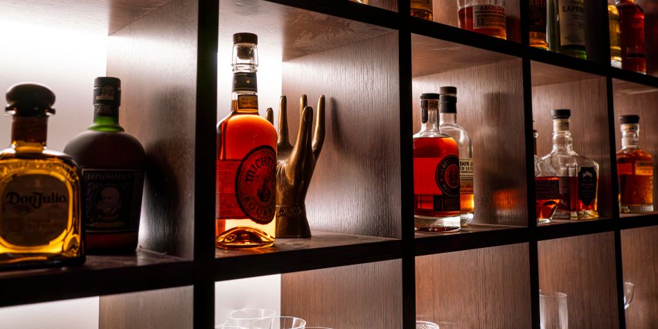 Backlit bar shelves with premium spirits at Loyall Counting Room.