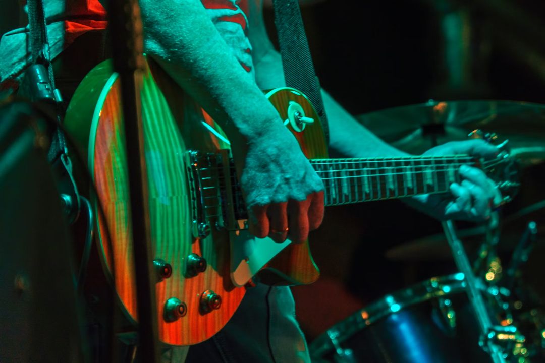 Musician playing an electric guitar.