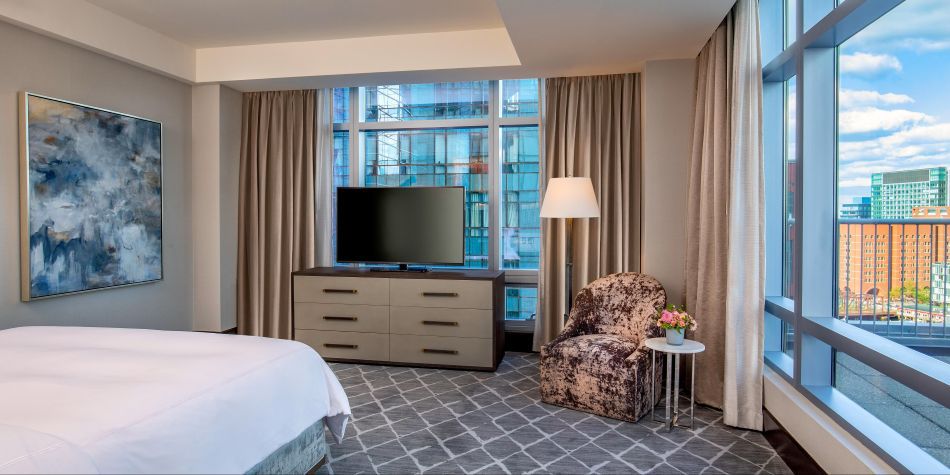 Penthouse suite bedroom with harbor and city views