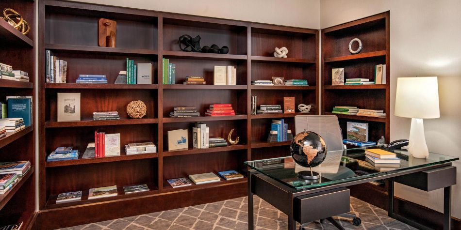Penthouse suite office with built-in bookcases and desk