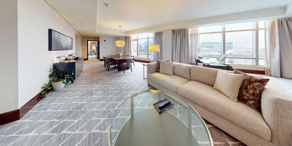 Penthouse South Suite living room with floor-to-ceiling harbor views
