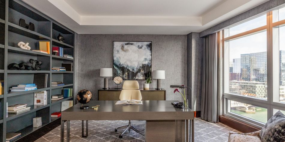 Presidential Suite office with desk and built-in bookshelves.