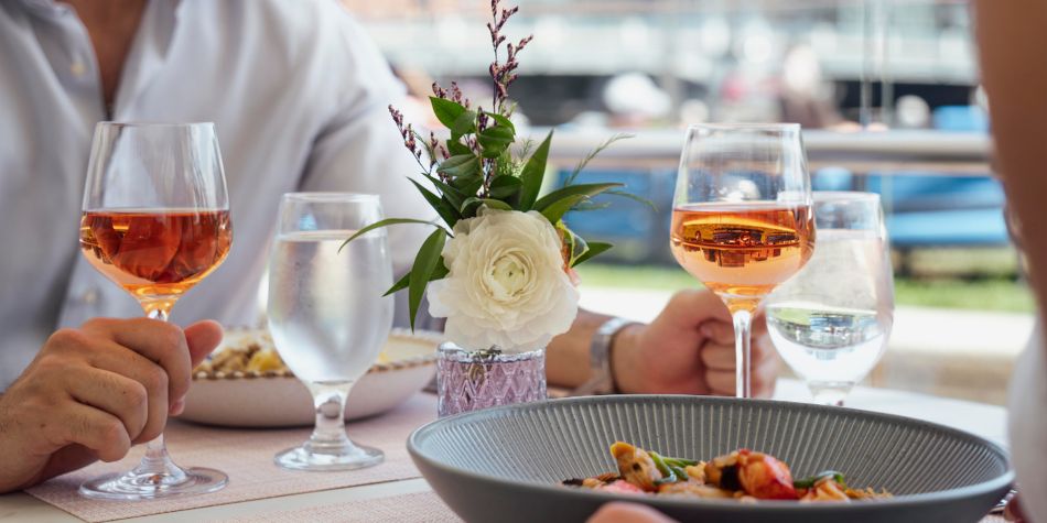 Guests enjoying rose and food.