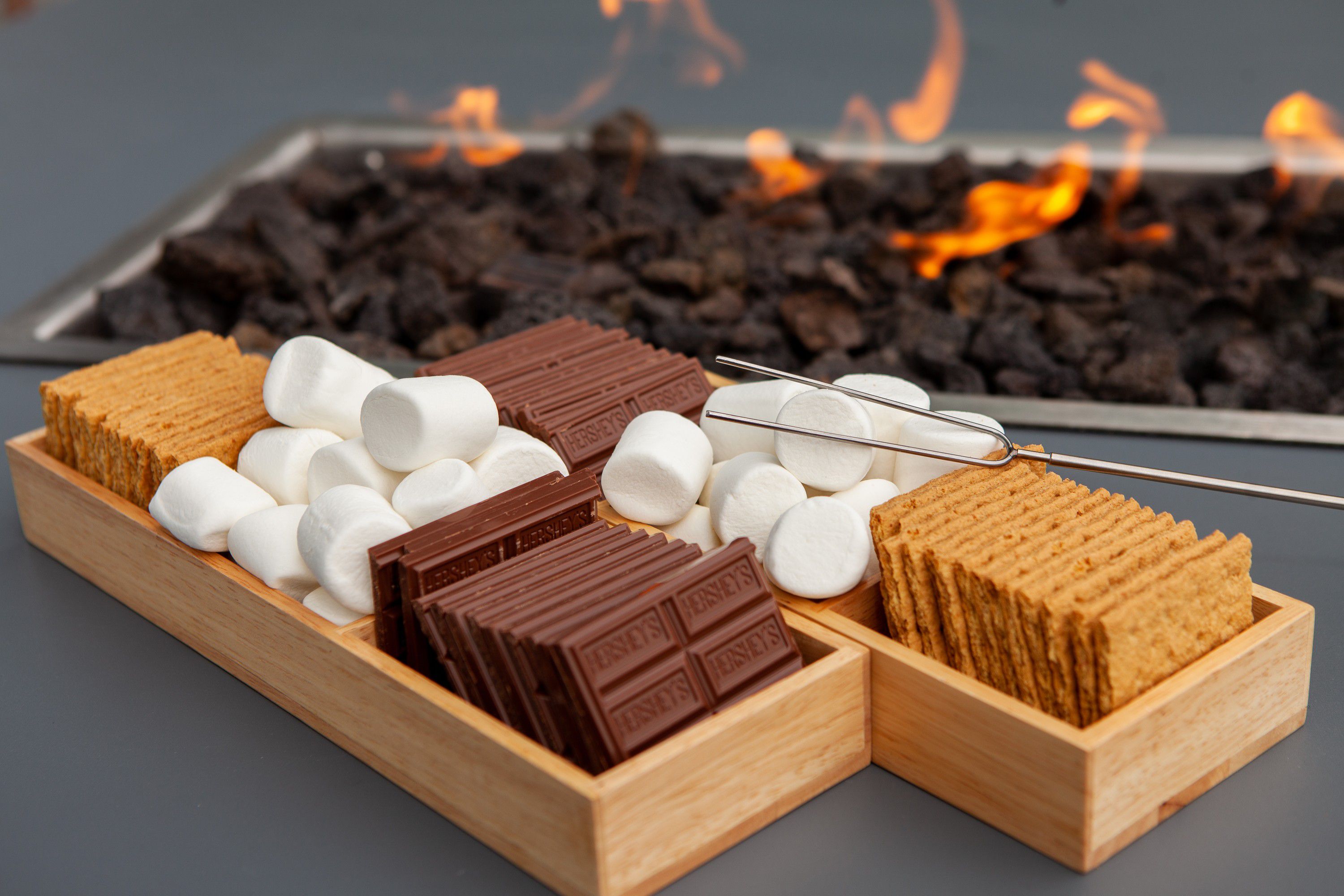 S'mores supplies by a firepit.
