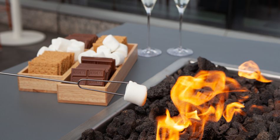 Cozy fall s'mores fire pit with marshmallows and chocolate.
