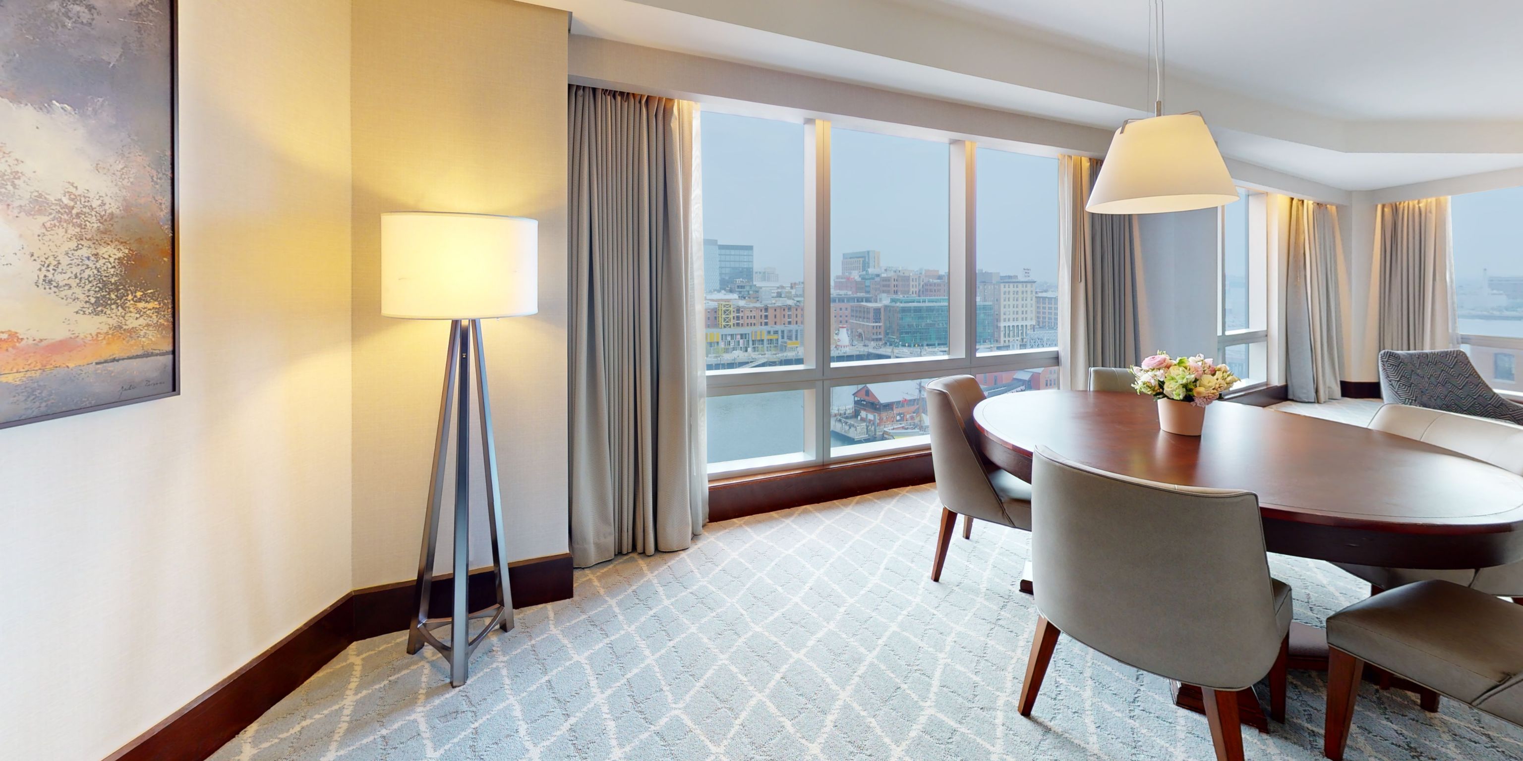 Elegant suite dining area with panoramic Boston harbor views
