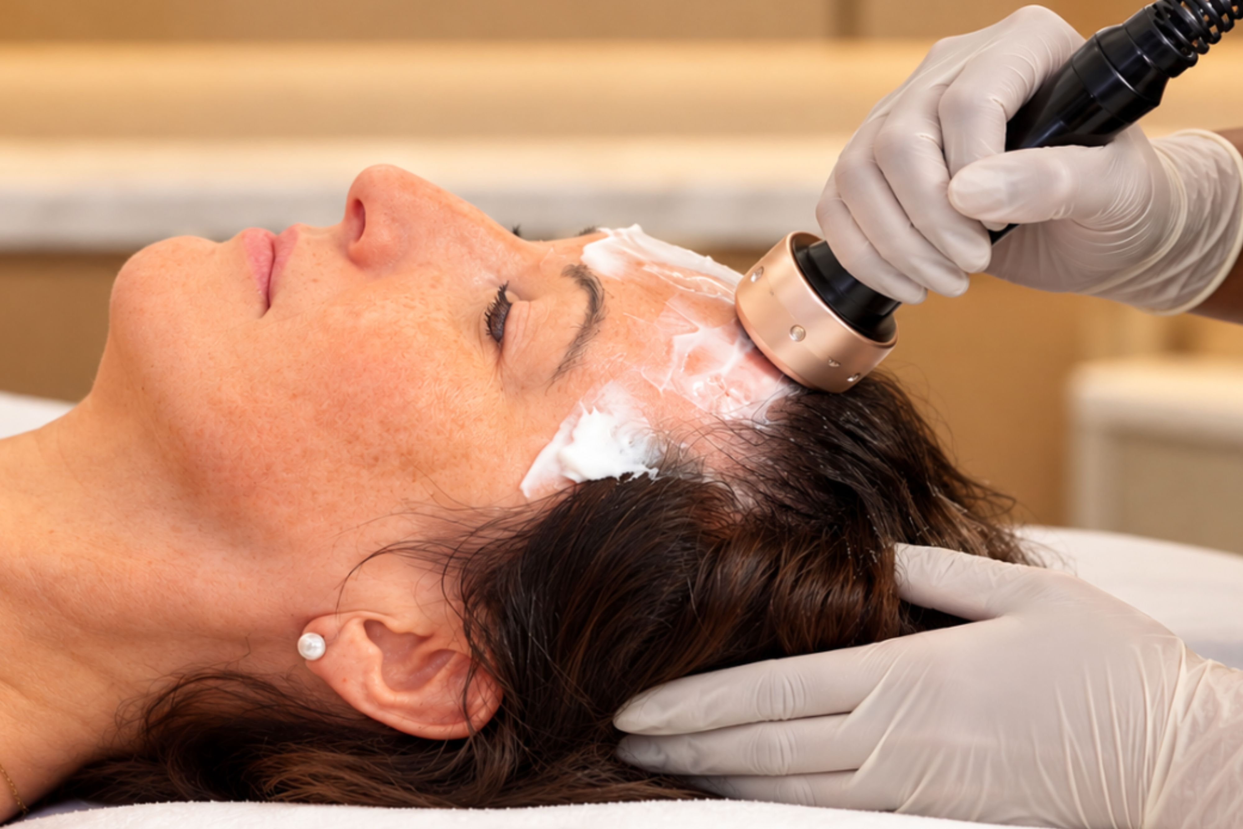 Woman receiving ultrasculpt spa treatment.
