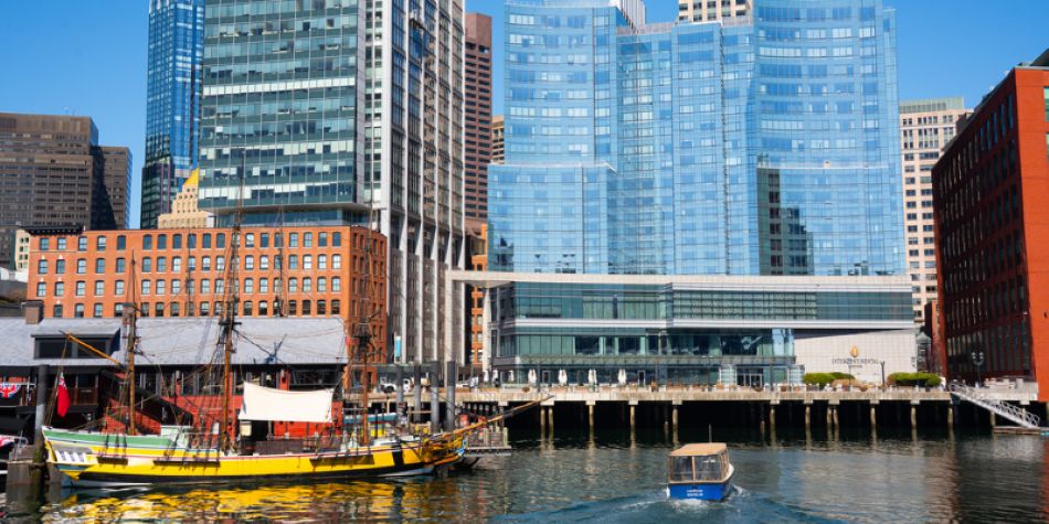 Water taxi driving through the water towards InterContinental Boston.