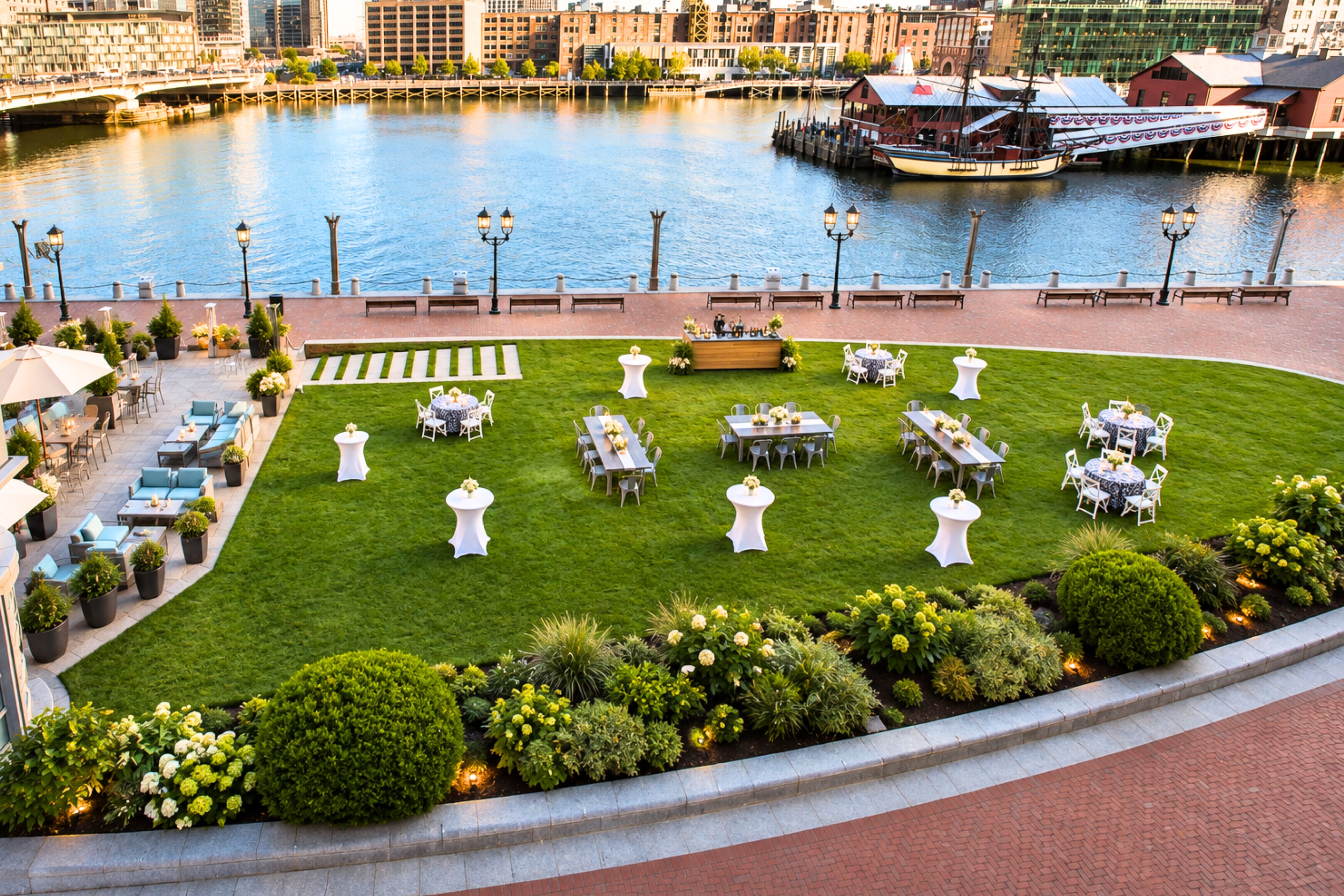 Waterfront lawn set for an outdoor event along Boston Harbor.