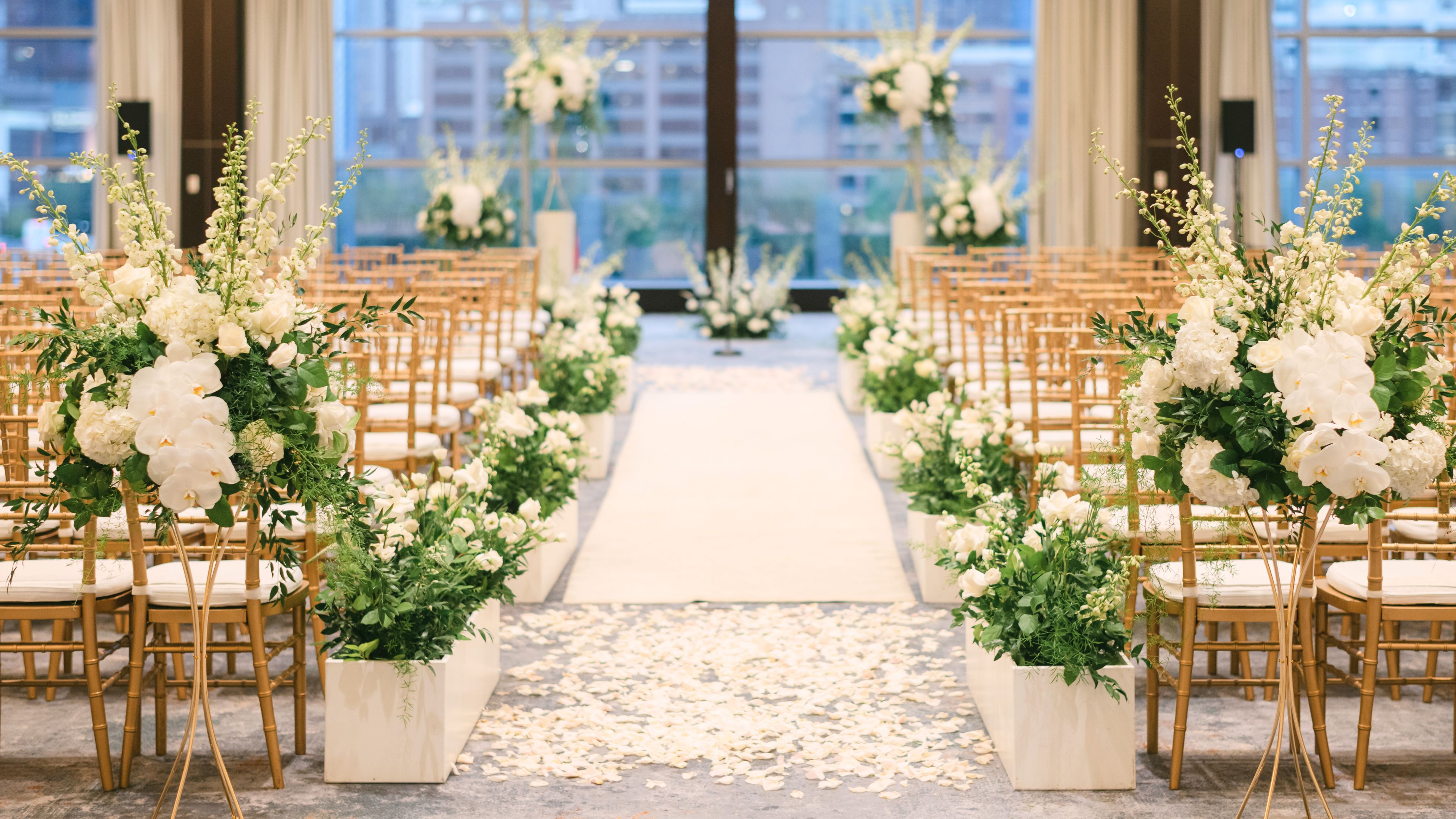 Wedding aisle set up with chairs and florals.