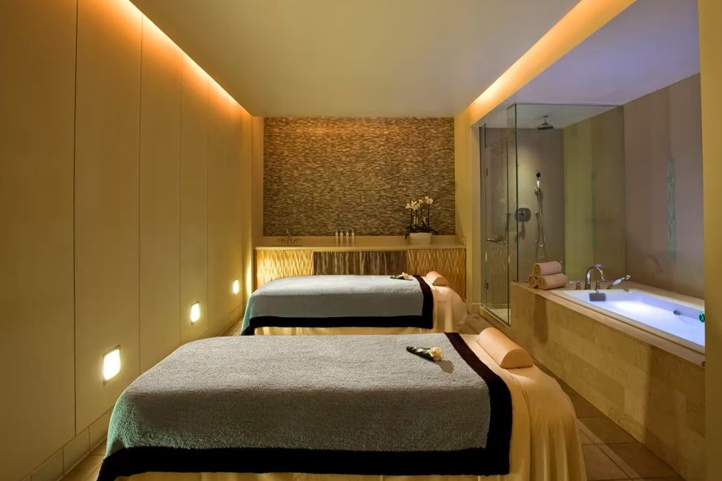 Relaxing spa with dimmed lighting and massage tables