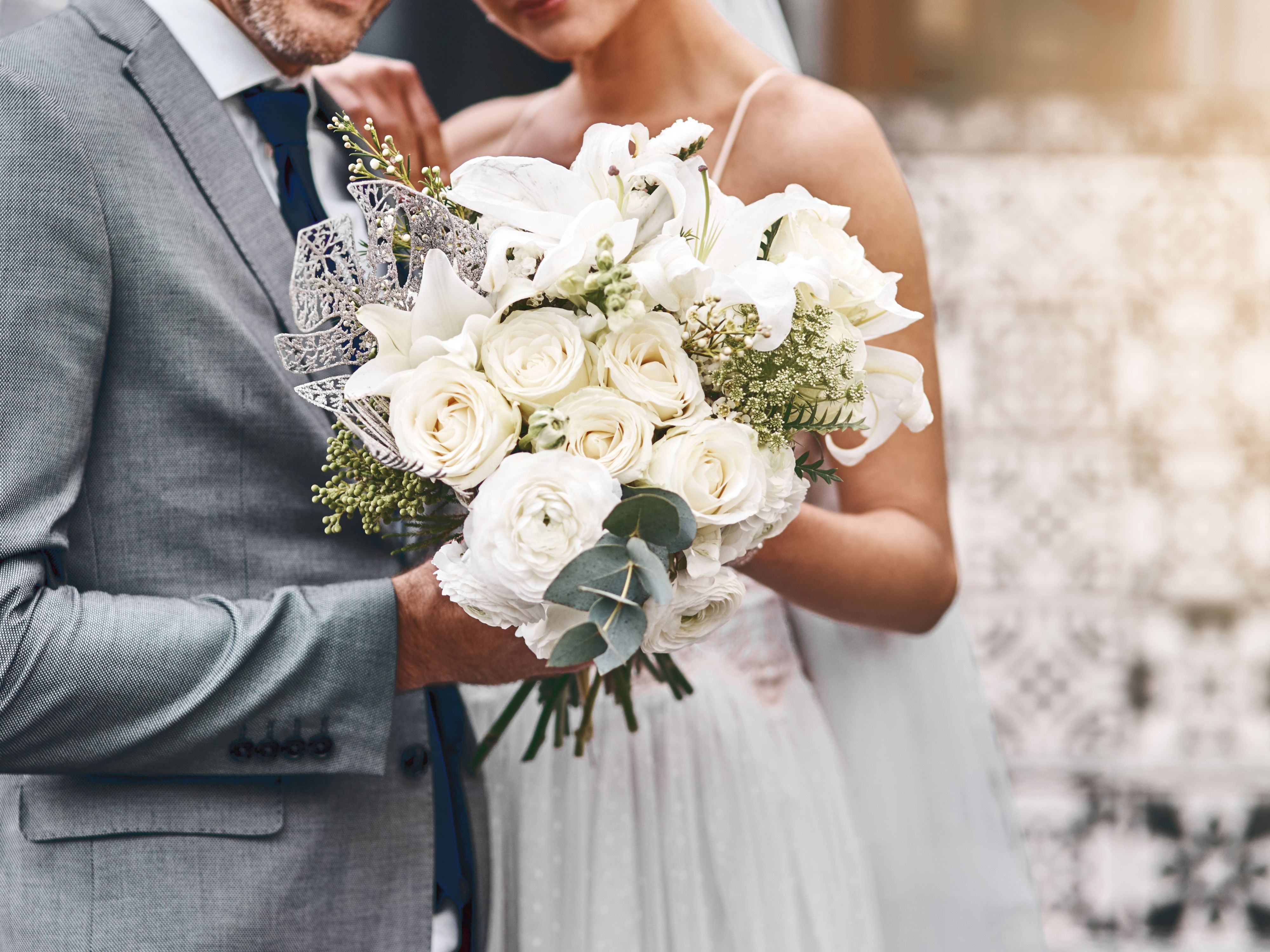 Bride and groom holding wedding bouquet