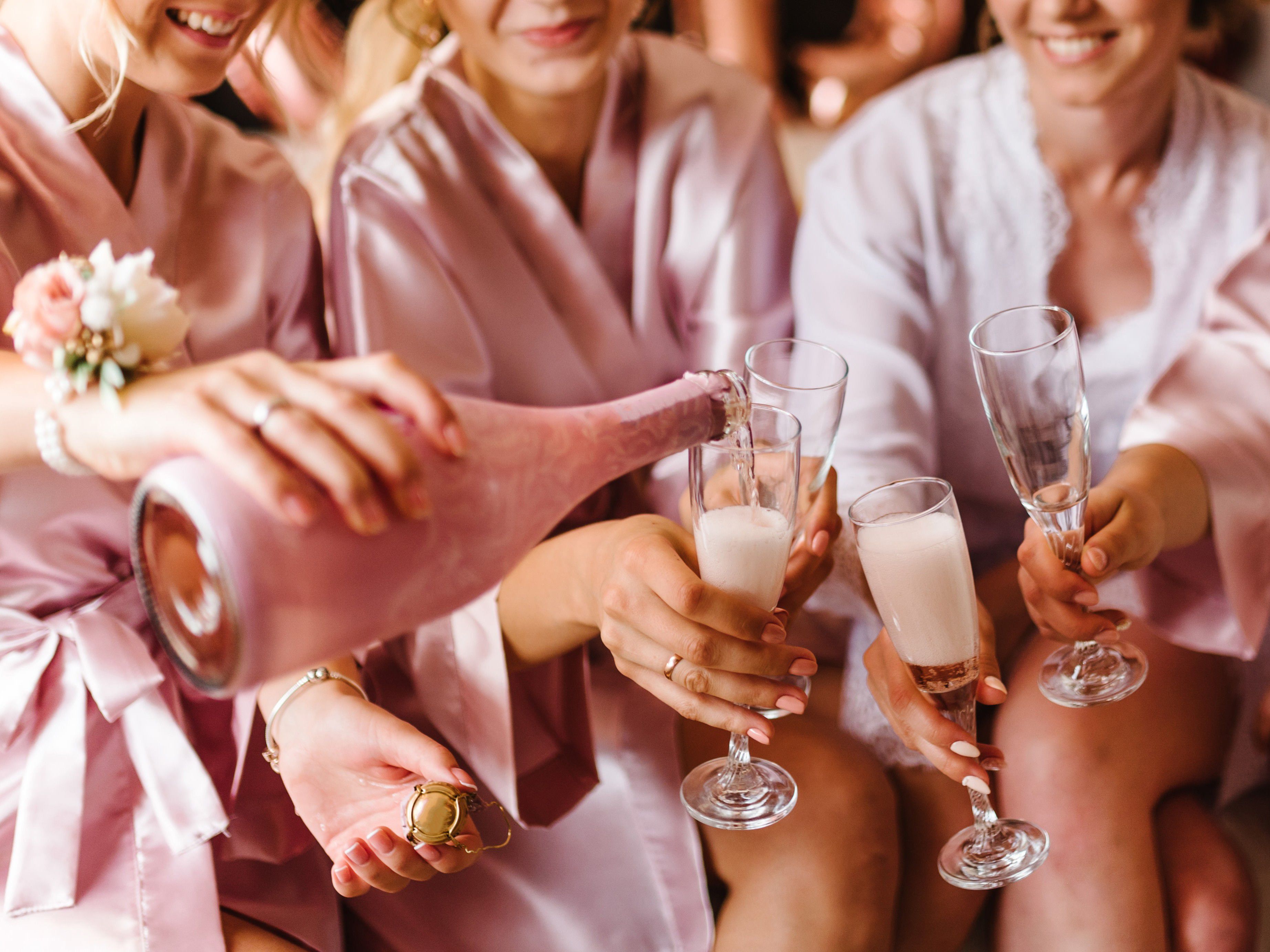 Bridesmaids pouring champagne