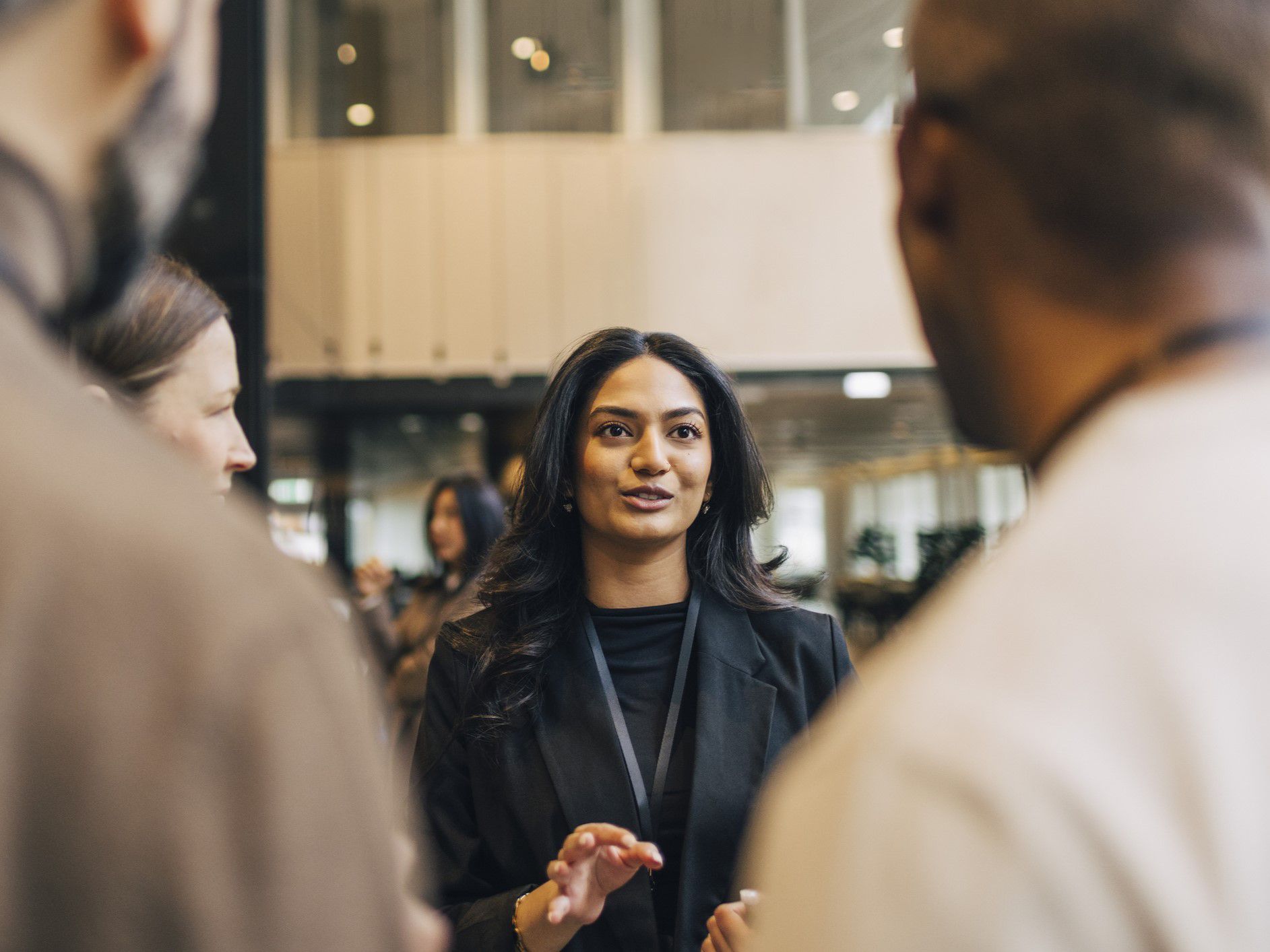 Business woman speaking with colleagues