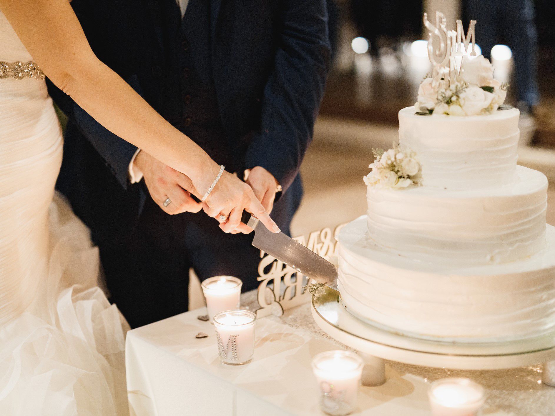 Bride and groom cutting a wedding cake.