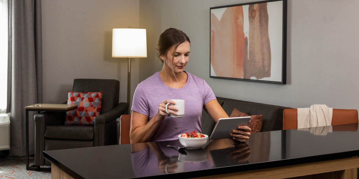 Hotel guest reading on tablet 