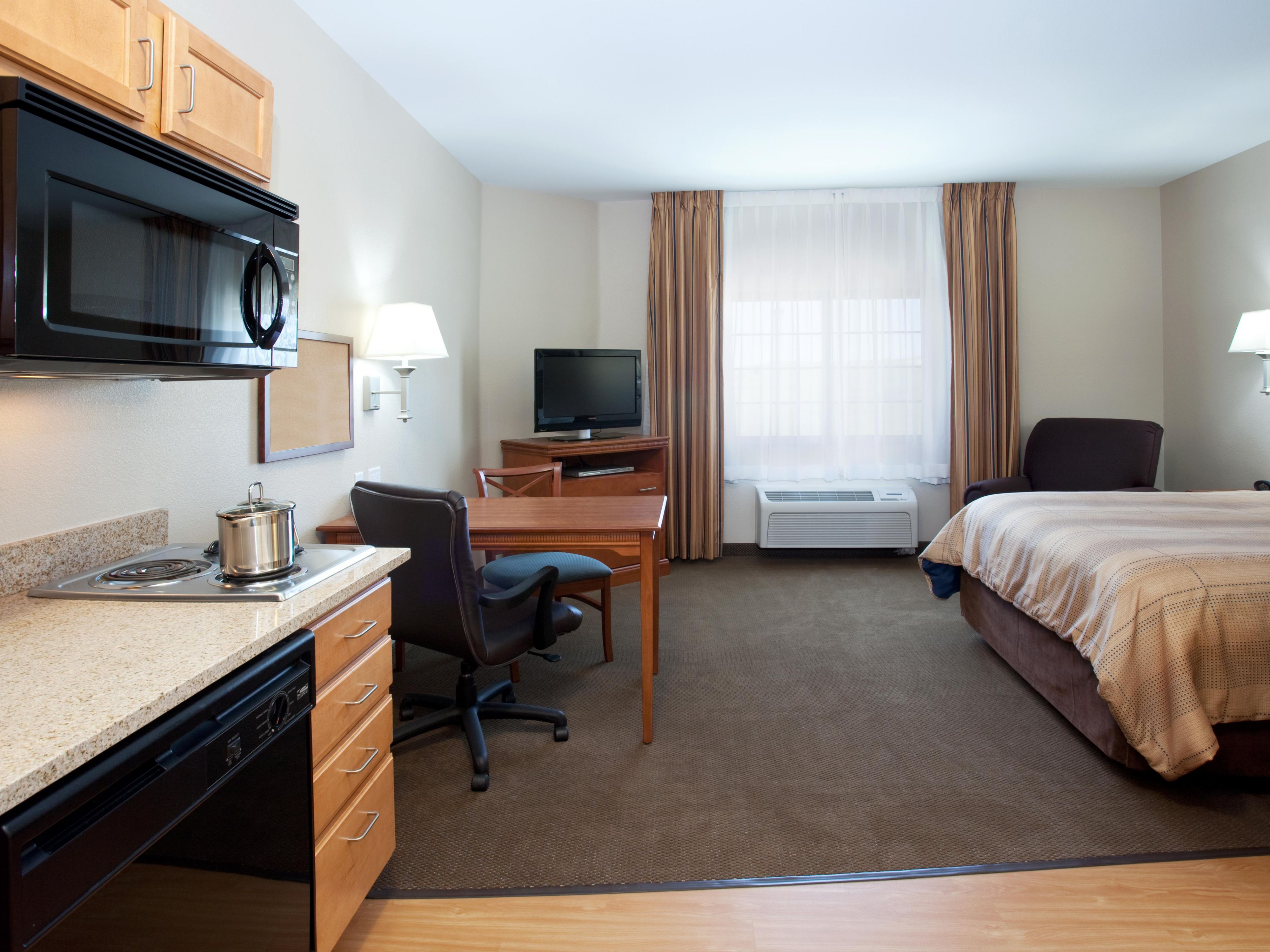 Work desk with chair in every suite at Craig's Candlewood Suites