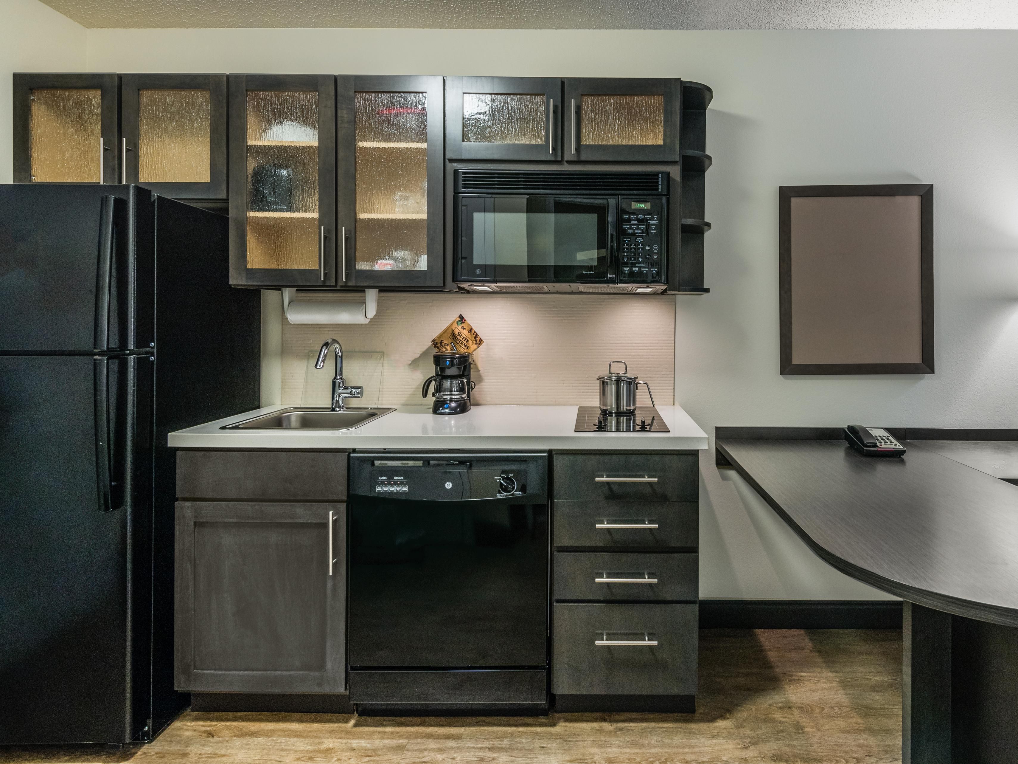 All guestrooms have fully equipped kitchens.  2 burner stove top, Full size refrigerator, dishwasher, microwave and coffee maker.  Kitchen is also supplied with all the plates, utensils, and cookware that you will need.