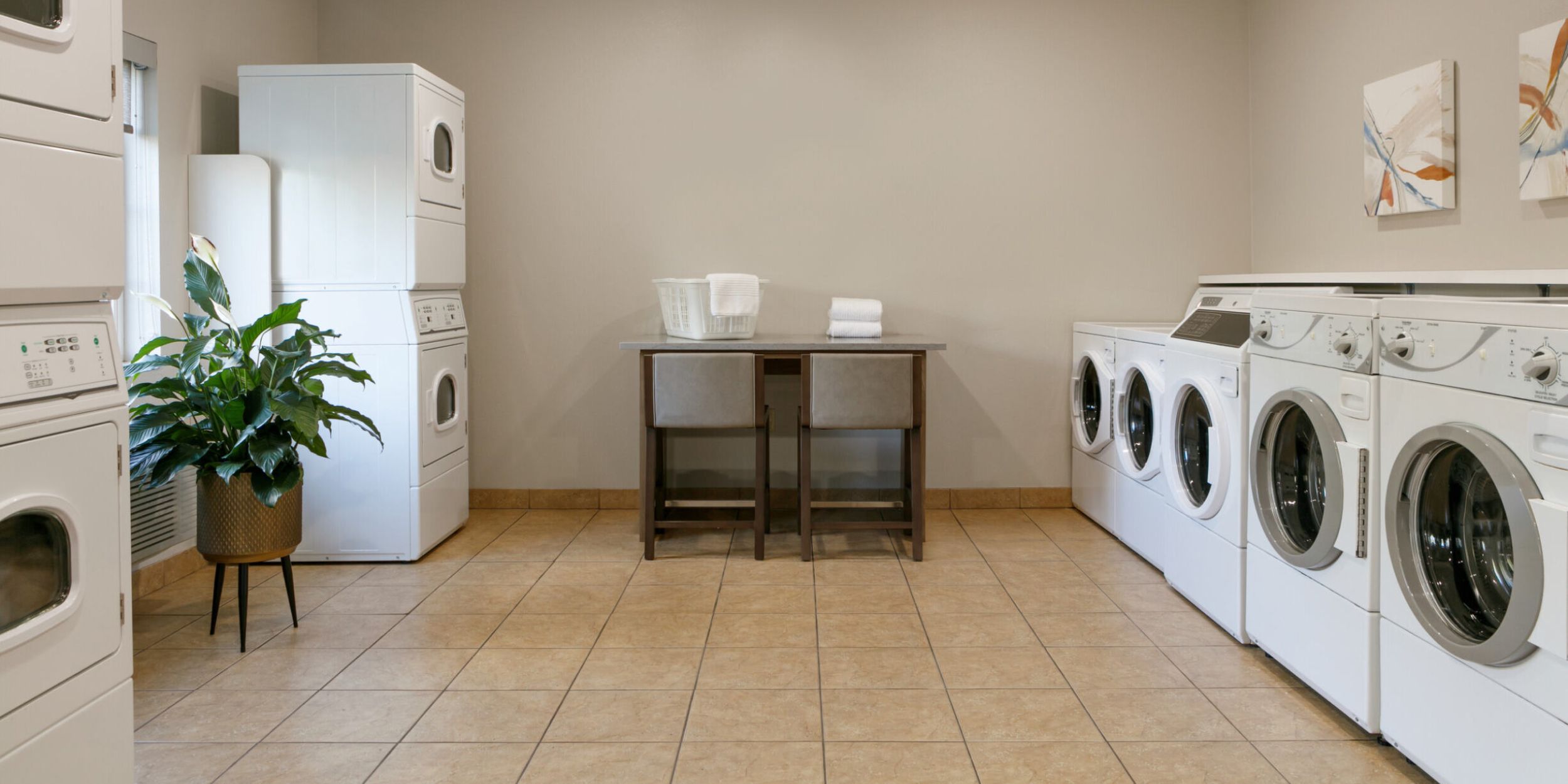 A guest putting clothes into a laundry machine in the laundry area of a hotel