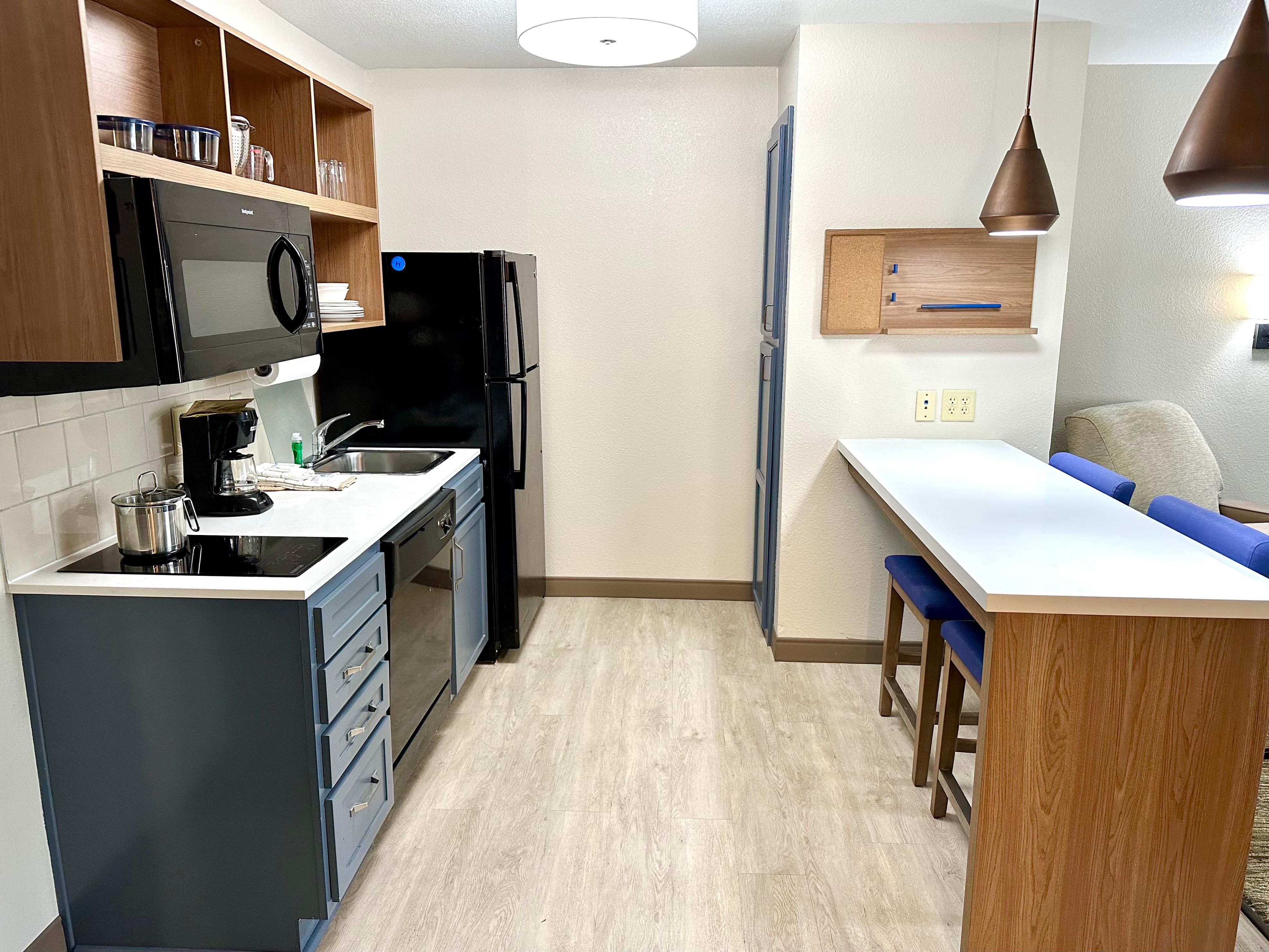 At our hotel, we want you to feel right at home. That's why all of our rooms are equipped with full kitchens, including a full size refrigerator, microwave, stovetop, dishwasher, toaster, and all the cooking and dining utensils you'll need. Experience the comfort and convenience of extended stay with us!