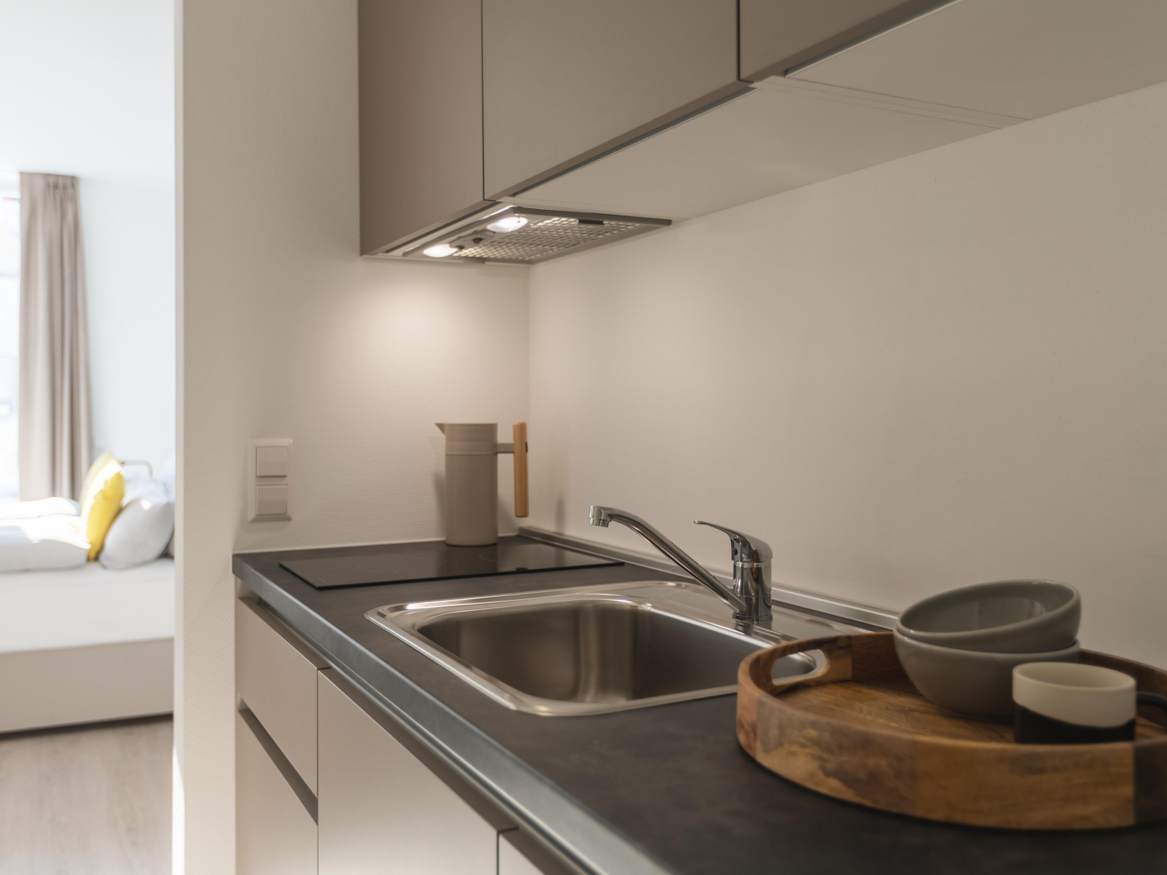 Make your own meals or enjoy breakfast right in your room. Each kitchen comes with a fridge, microwave, hotplates, dishwasher, and coffee pod machine, offering comfort and flexibility for long-stay guests, business travelers, and families—truly a home away from home.
