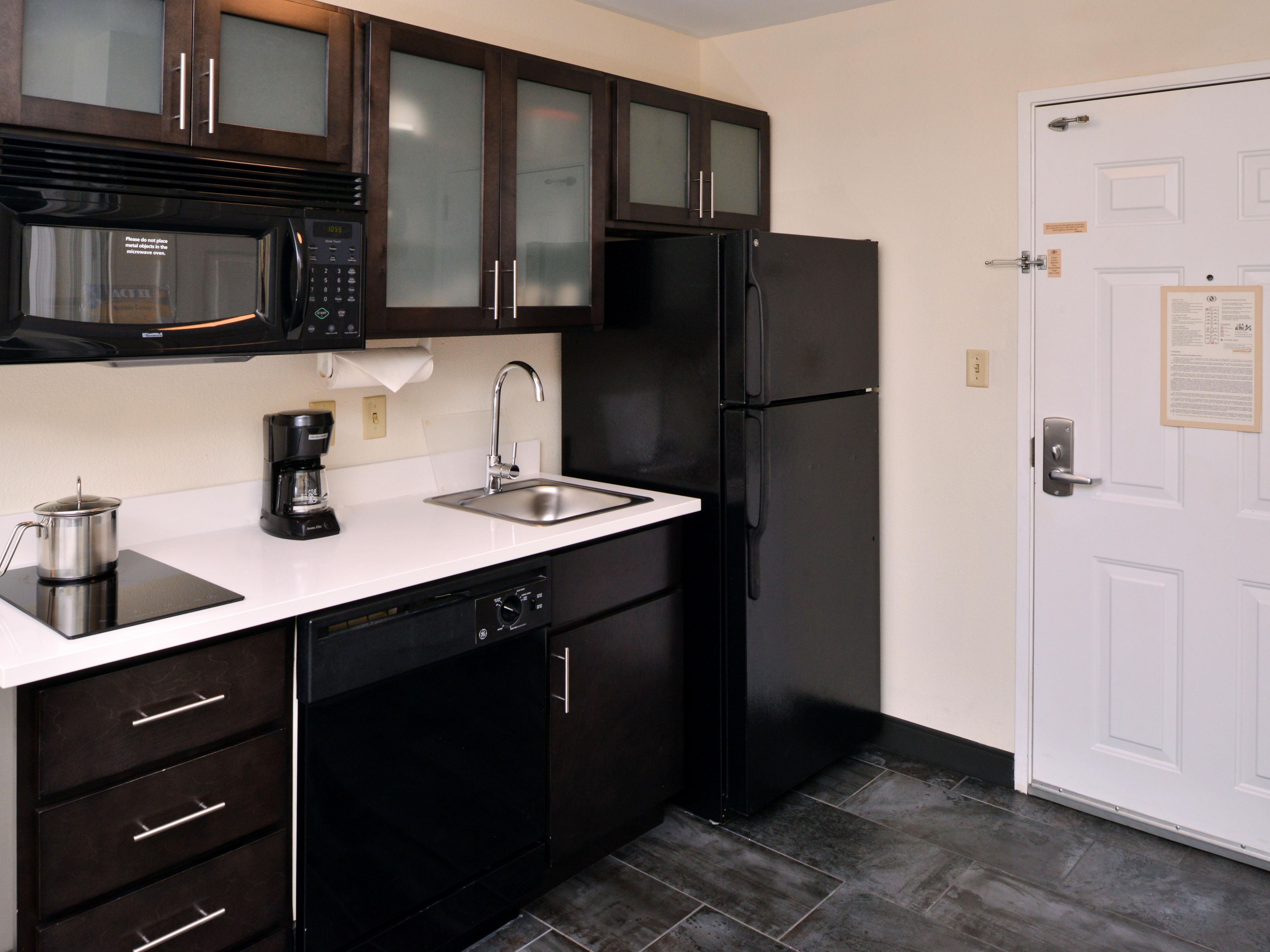 Enjoy the convenience of a full kitchen in every suite, complete with a stove, microwave, refrigerator, and dishwasher - ideal for both short and extended stays.