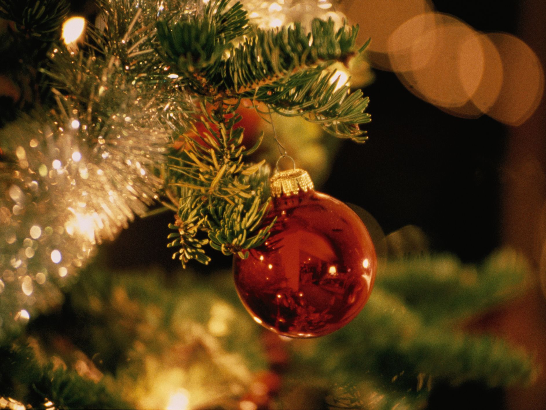 Christmas tree with lights and red ornament.