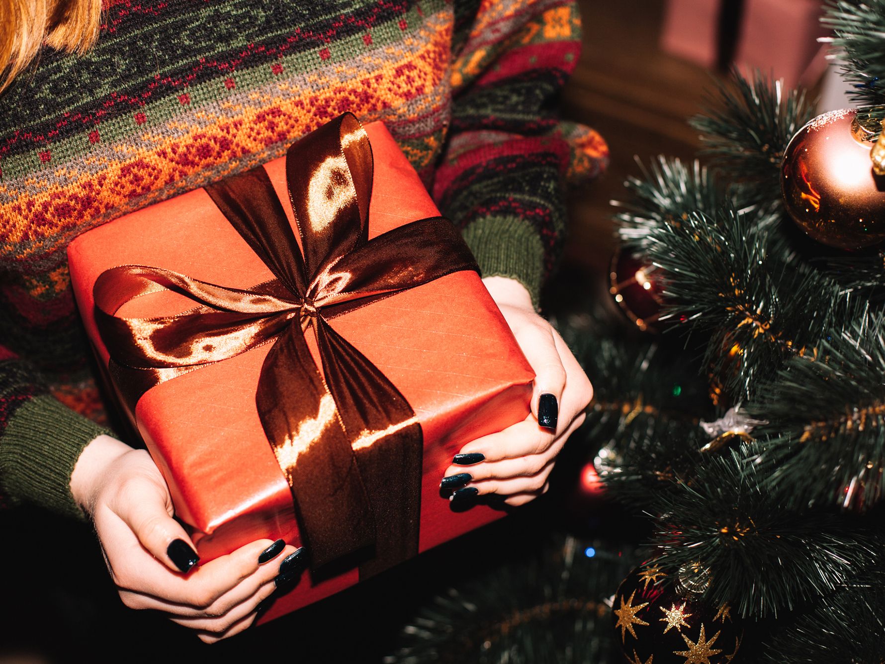 Guest holding a red present