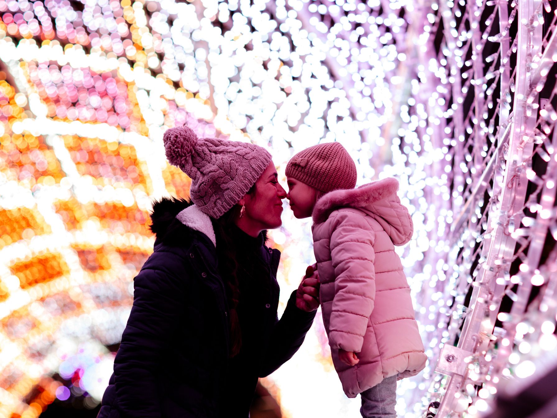 Mom and daughter in light tunnel