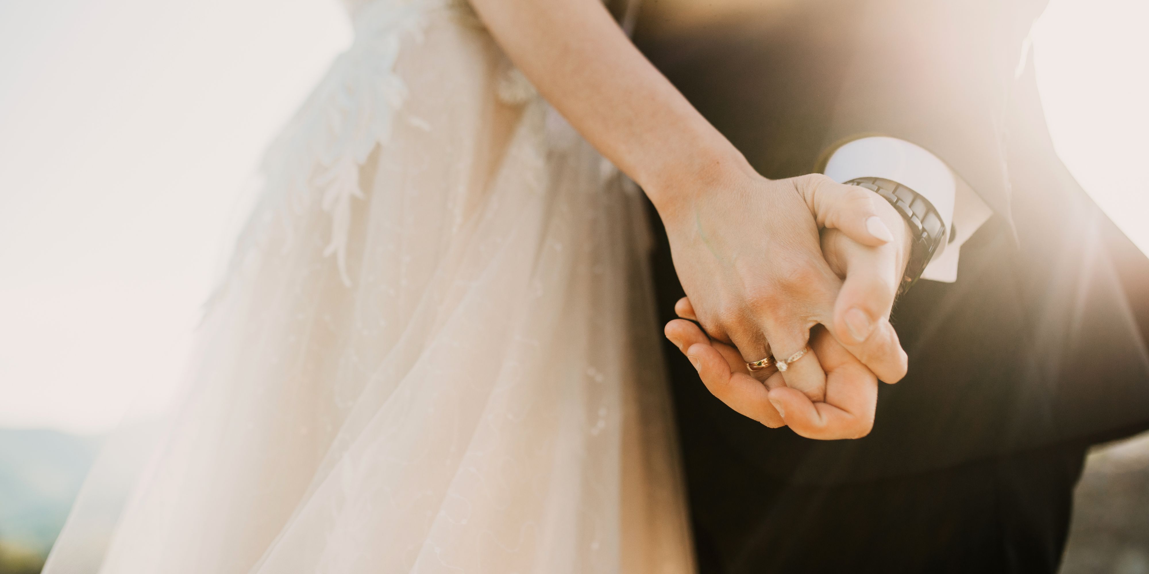 bride and groom holding hands