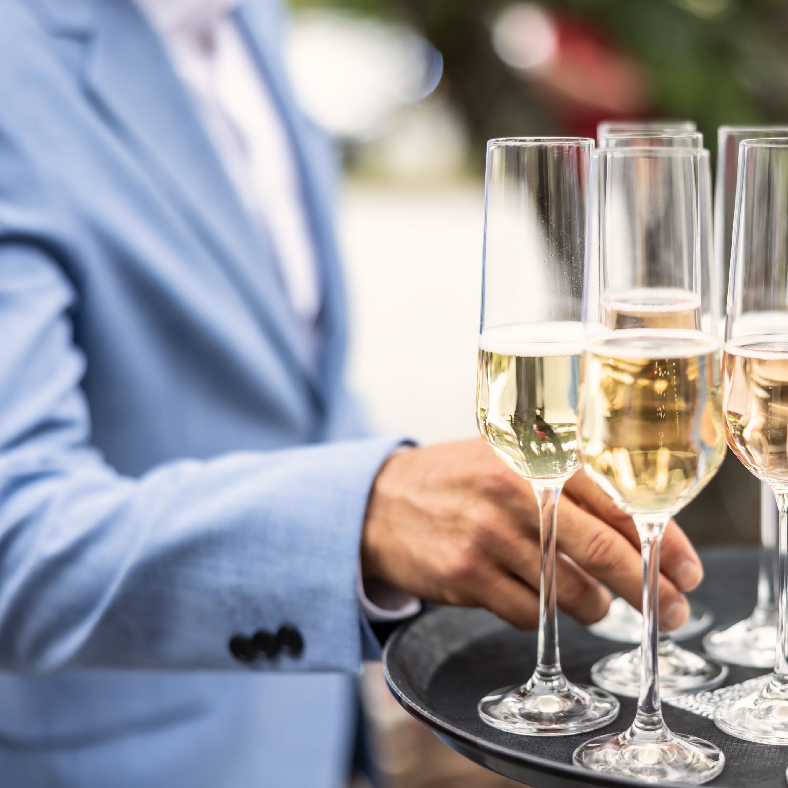 wedding guest getting champagne off tray