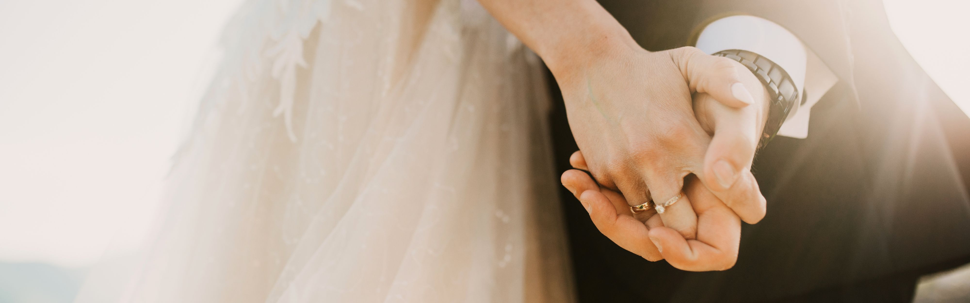 bride and groom holding hands