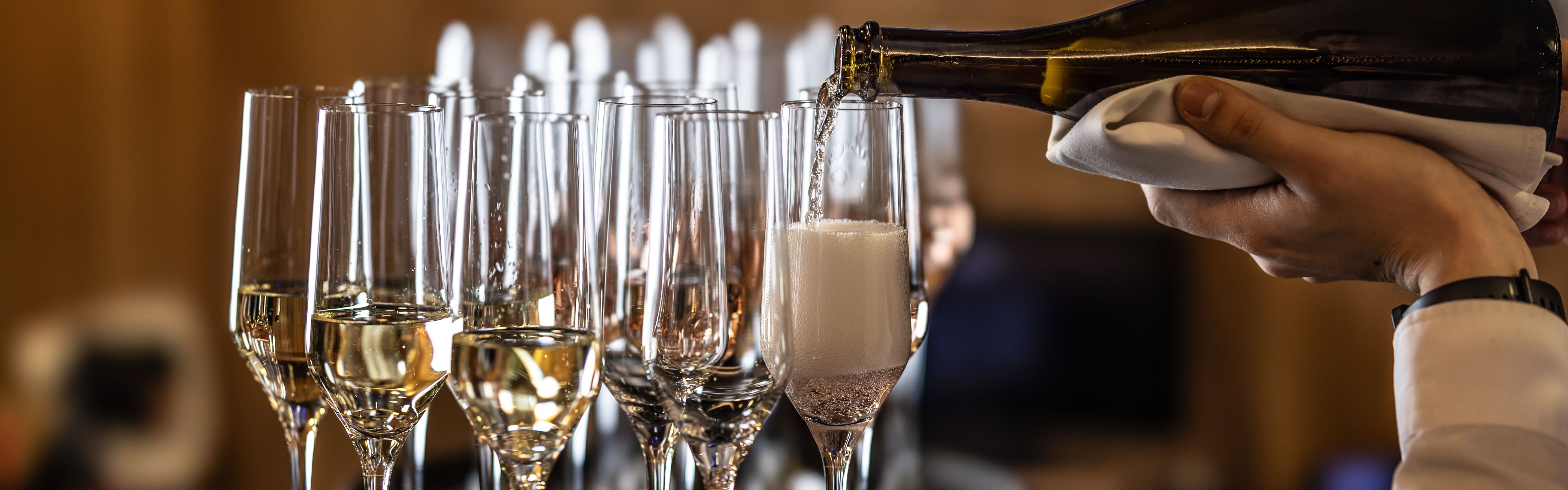 Sparkling wine poured into champagne glasses
